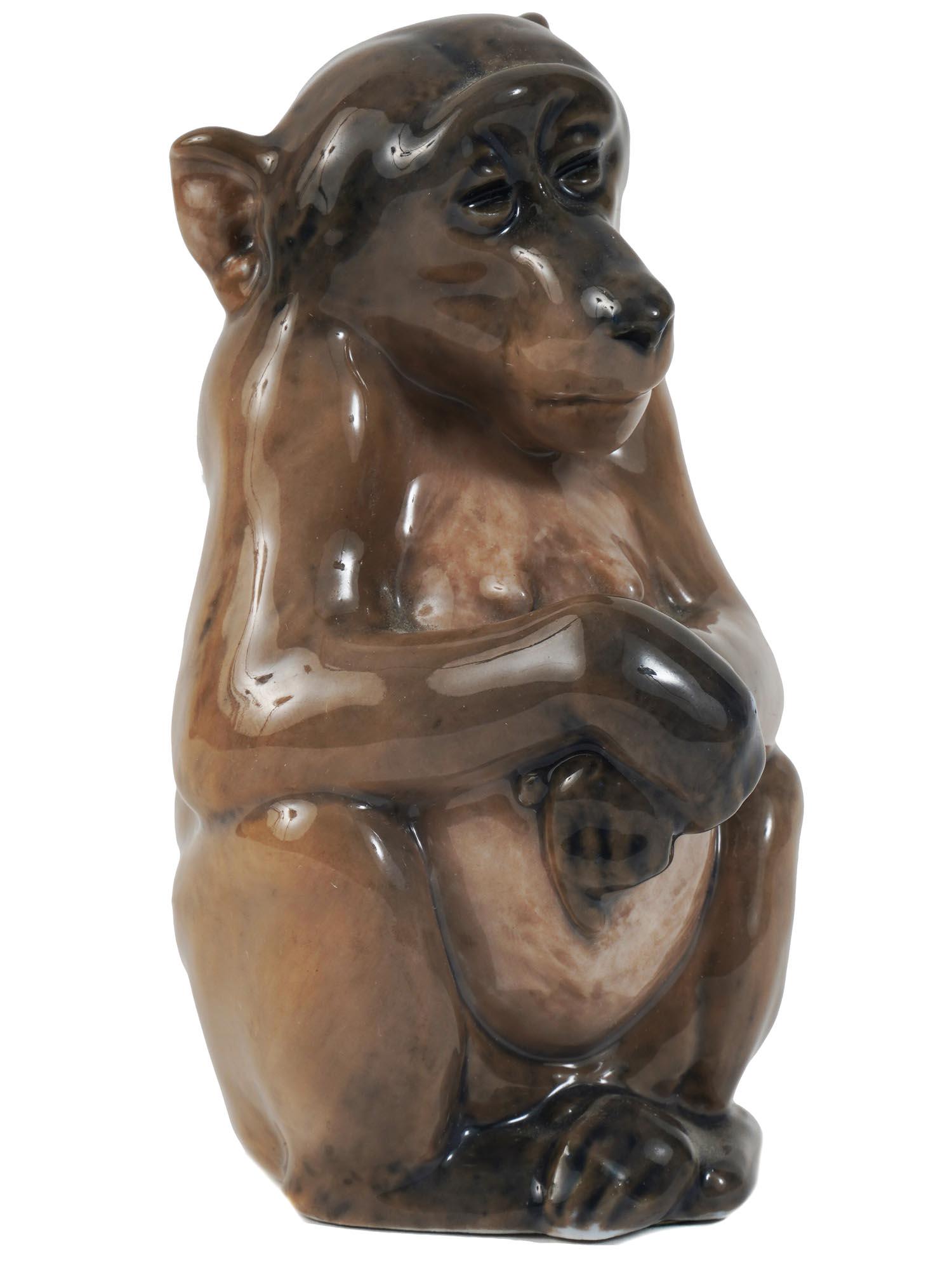ANTIQUE ROYAL COPENHAGEN PORCELAIN MONKEY FIGURE: An antique Danish Royal Copenhagen Art Nouveau porcelain figurine of a monkey. Marked to the bases with the manufacturer stamps and model numbers 1444 and 1454. Circa the early 20th century. Antique D