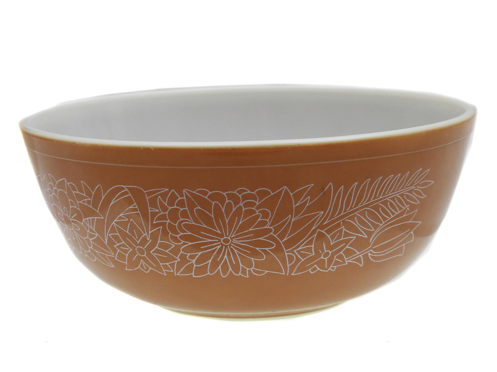A VINTAGE PYREX BOWL WOODLAND PATTERN: A Vintage Mixing Bowl In The Woodland Pattern By Pyrex. Light Brown With A Delicate Design Of White Flowers And Leaves. Made In USA. Circa: 1960s. Dimensions: H: 4 1/2 in. D: 10 1/4 in.