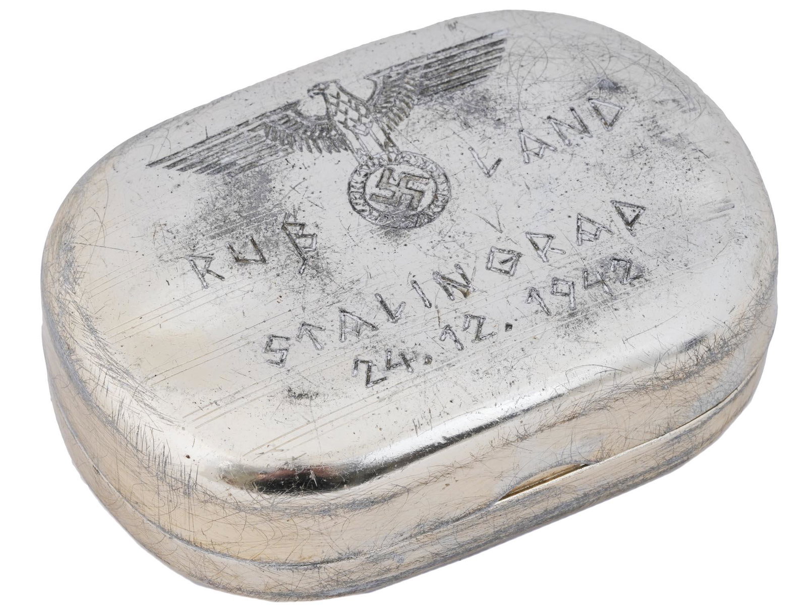 GERMAN WWII BATTLE FOR STALINGRAD TRINKET BOX: A WWII German Nazi aluminum trinket box. Decorated on the top with the engraved national eagle to the center clutching a wreath with a swastika inside and featuring the letterings Russland on both sid