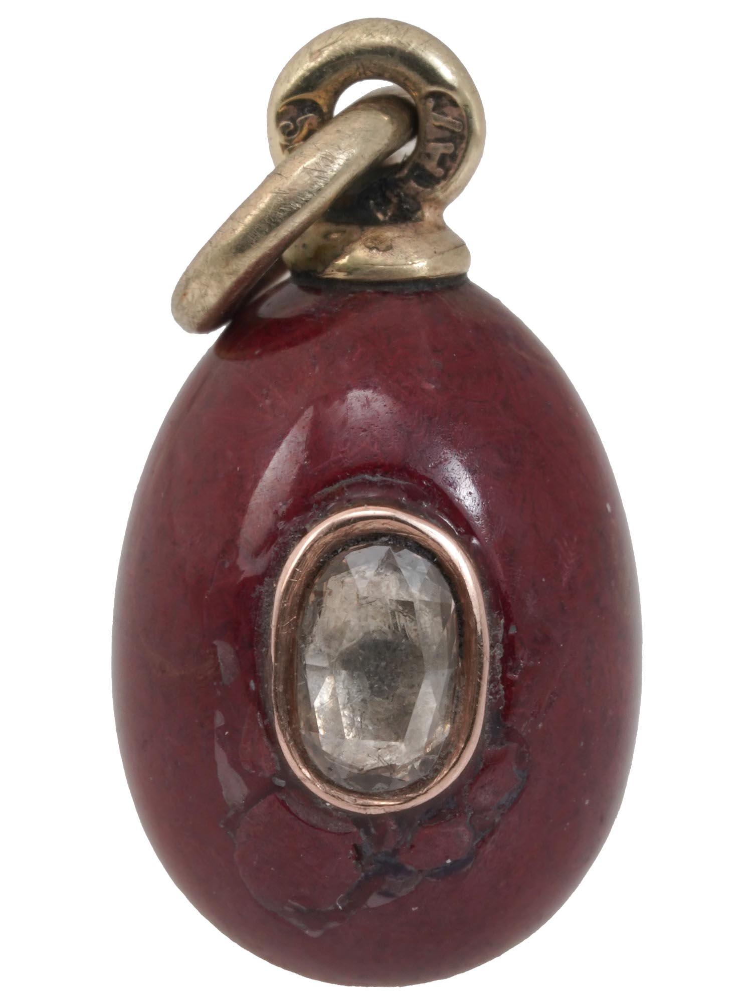 RUSSIAN GOLD JASPER EGG PENDANT WITH DIAMOND: A Russian red jasper egg charm with gold fittings. The recto side of the pendant is garnished with an oval diamond. Hallmark 56 gold standard and makers mark are on the suspension ring. Weight: 3 gram
