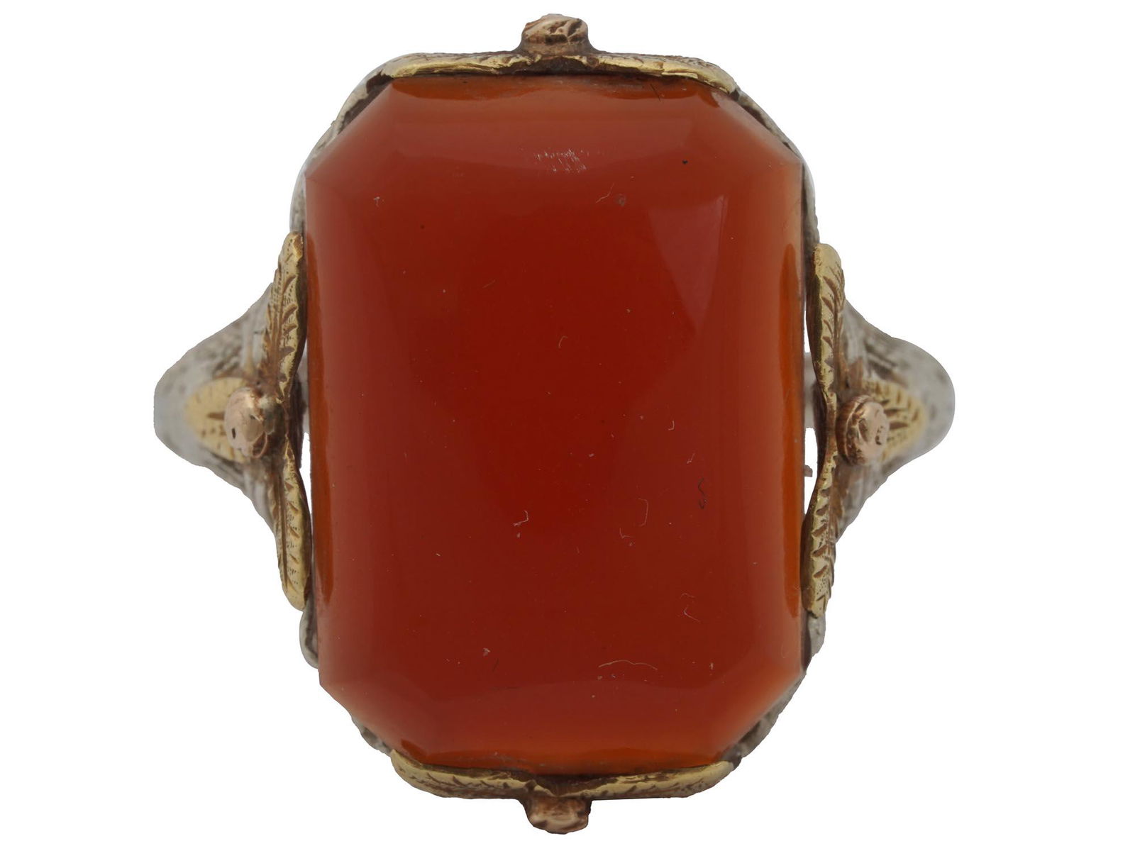 WHITE WILE AND WARNER 14K GOLD SILVER AGATE RING: An antique 14K gold and silver cocktail ring with a large red agate cabochon. The ring is decorated with a Victorian style floral metalwork. Hallmark WWW is on the inside. Weight: 4.7 grams. WWW stand
