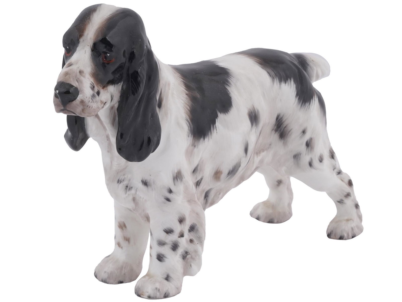 ENGLISH ROYAL DOULTON PORCELAIN FIGURINE OF A DOG: An English, British, Royal Doulton glazed porcelain figurine. The figurine depicts a Spaniel dog. Marked with a green ink factory mark, a JS mark, and numbered HN 1109, on the bottom. Royal Doulton is