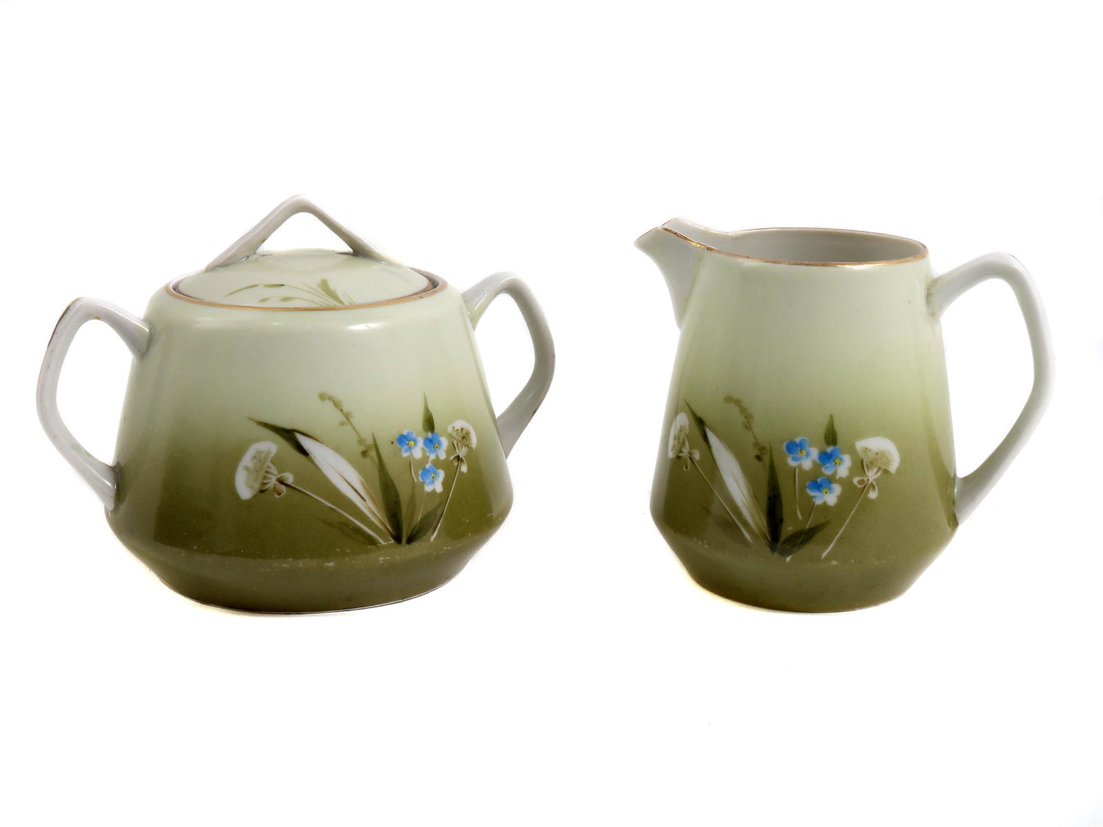 AN EARLY SOVIET PORCELAIN CREAMER AND SUGAR BOWL: A vintage Russian Soviet porcelain creamer pitcher and a lidded sugar bowl, Dmitrovsky porcelain factory Verbilki. Painted with compositions of wildflowers on a white-green background, decorated with