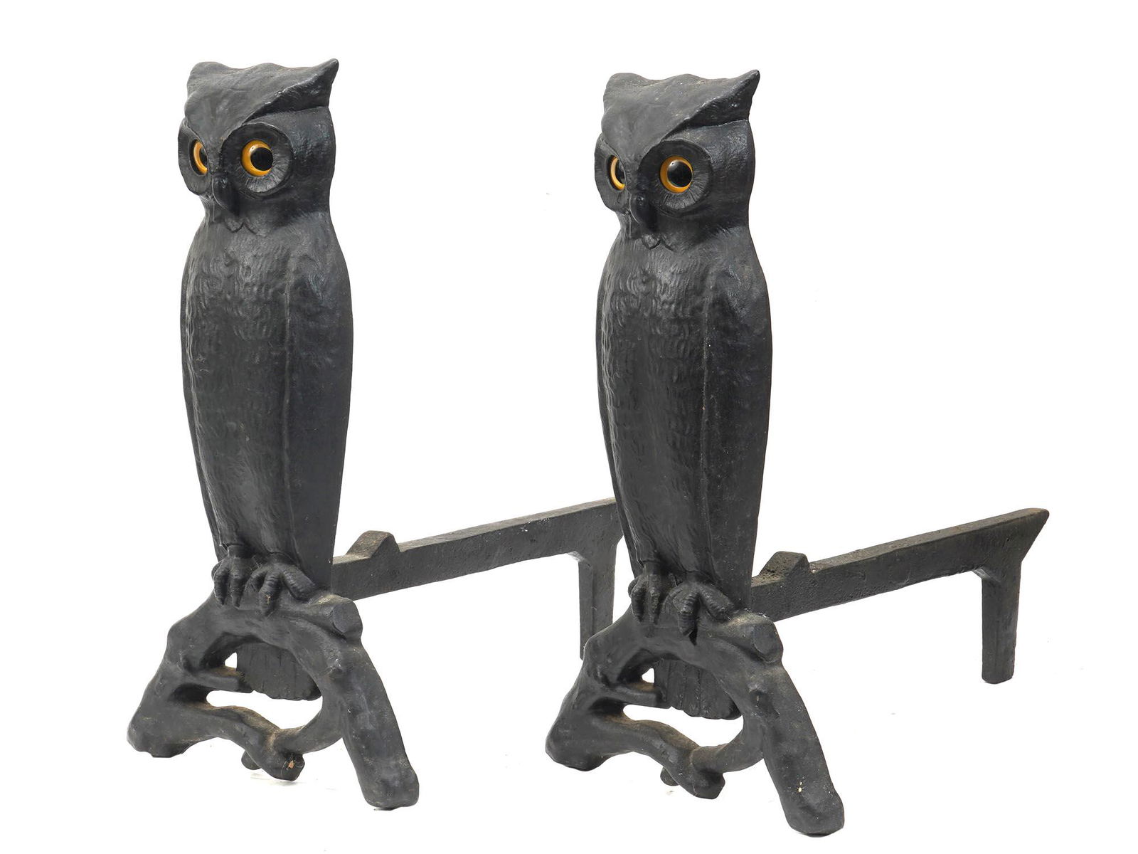 CAST IRON OWL ANDIRONS FIREPLACE ACCESSORIES: A pair of finely cast fireplace andirons modeled as two owls. The eyes are set with bright glowing yellow amber glass. Dated from the first half of the 20th century. Antique Fireplaces, Mantels And Fi