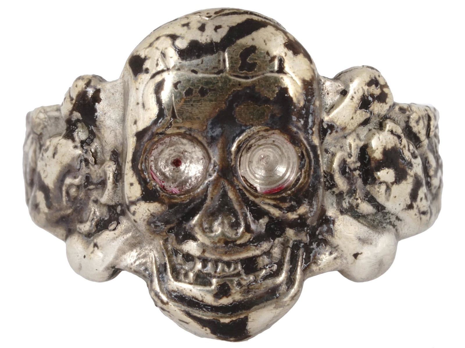 WWII GERMAN NAZI TOTENKOPF OFFICERS SILVER RING: A WWII era German Nazi Third Reich Waffen SS Totenkopf division officers silver ring. The ring is adorned with engraved patterns and a relief image of a skull, a Totenkopf swastika insignia and encrus