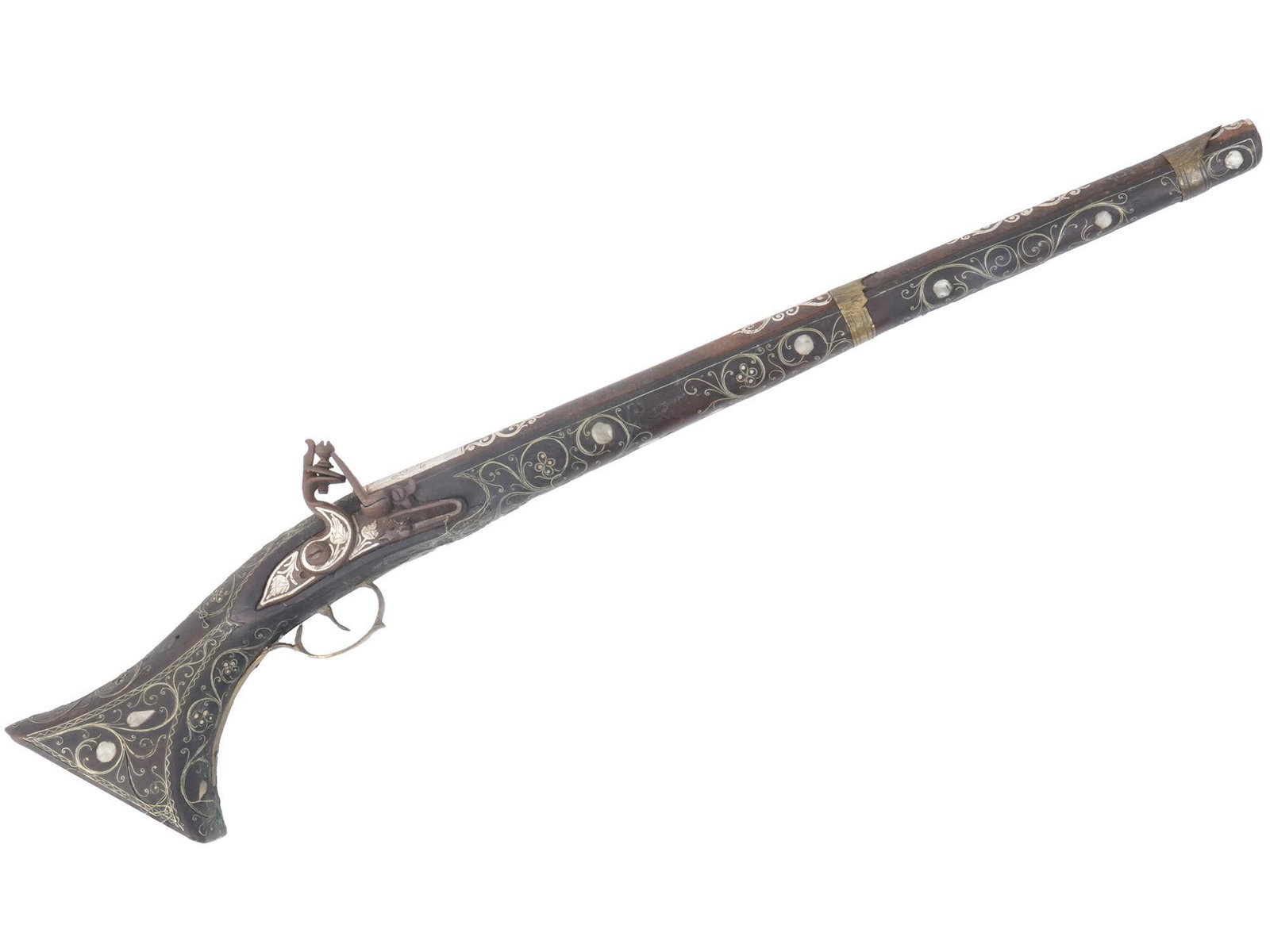 19TH CEN. OTTOMAN SILVER INLAID FLINTLOCK PISTOL: An antique early 19th century Ottoman Turkish flintlock pistol made in wood and skillfully inlaid with silver, brass and mother-of-pearl elements. The silver parts are also ornate with hand-engraved f