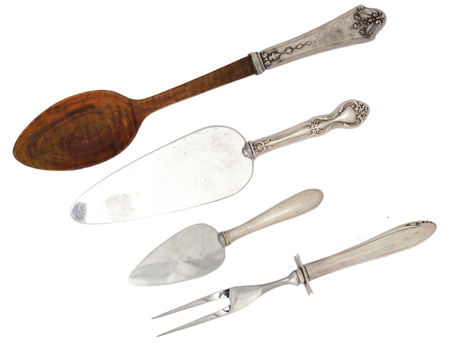 AMERICAN SERVEWARE WITH STERLING SILVER HANDLES: A lot of early to mid-20th century American stainless steel serveware with sterling silver handles. A total of 4 items including two spatulas of various size, a carving fork, and a wooden serving spoo
