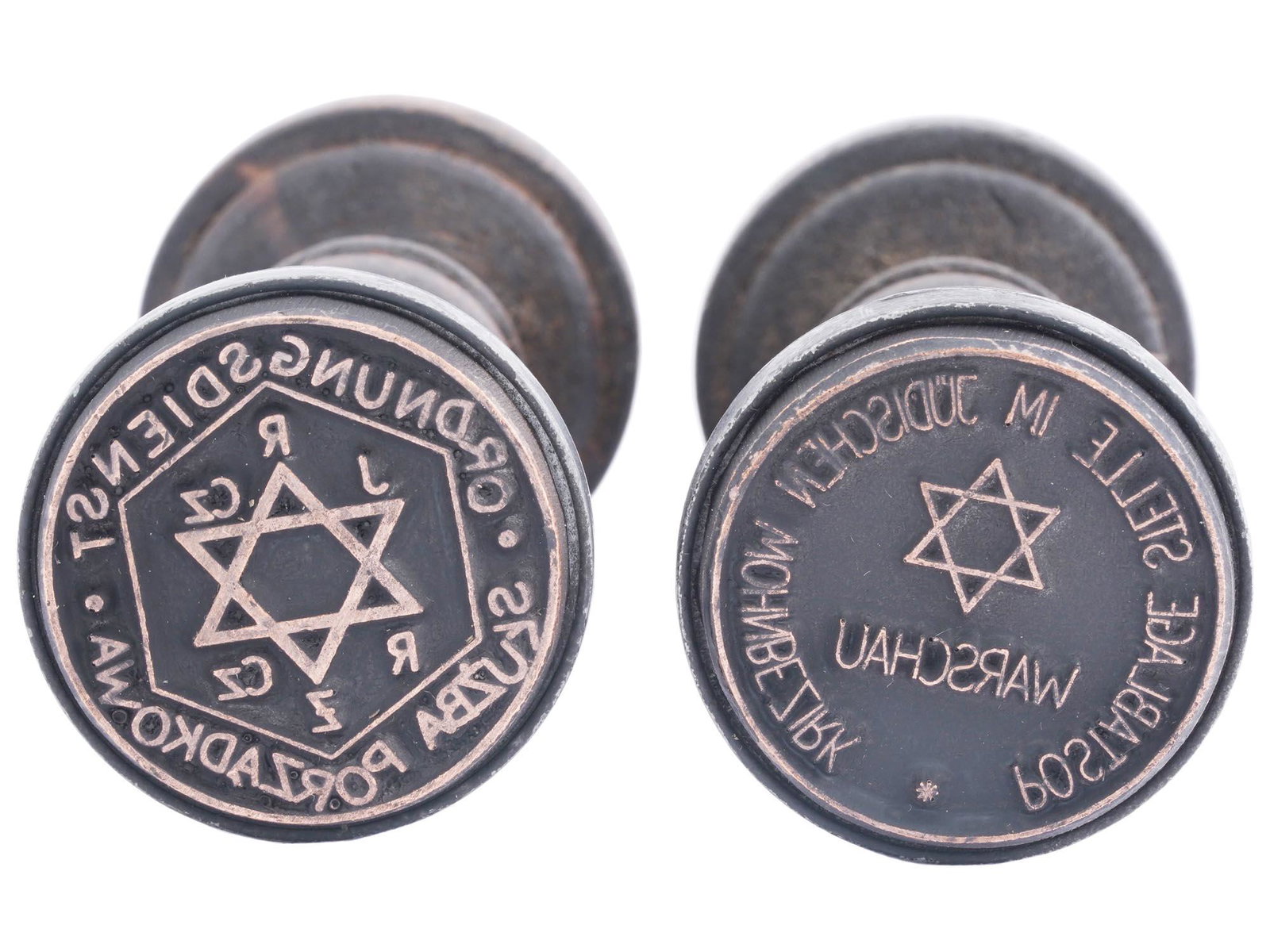 WWII HOLOCAUST WARSAW JEWISH GHETTO POSTAGE SEALS: A pair of 1940s Polish wooden seals of Warsaw ghetto post. The first seal has a Magen David and inscription Postablage Stelle in Judischen Wohnbezirk Warschau, a Post office in the Jewish residential 