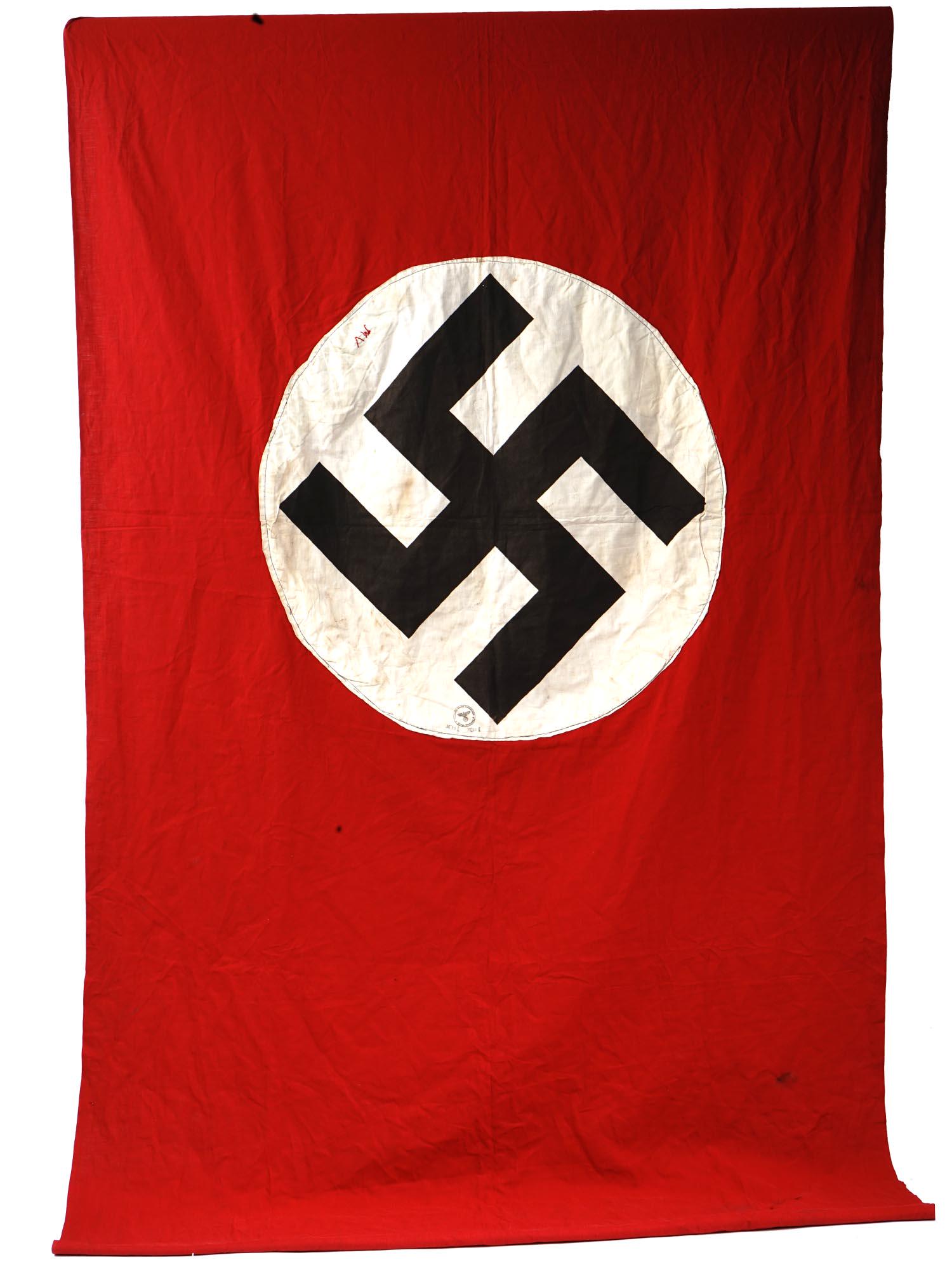 WWII ERA NAZI GERMAN PARADE FLAG WITH SWASTIKA: A large 1930-1940s Nazi German red cloth banner with swastika. The flag has an original manufacture stamp and hand-embroidered initials MV. WW2 Historical Relics And Collectables, Nazi German Insignia