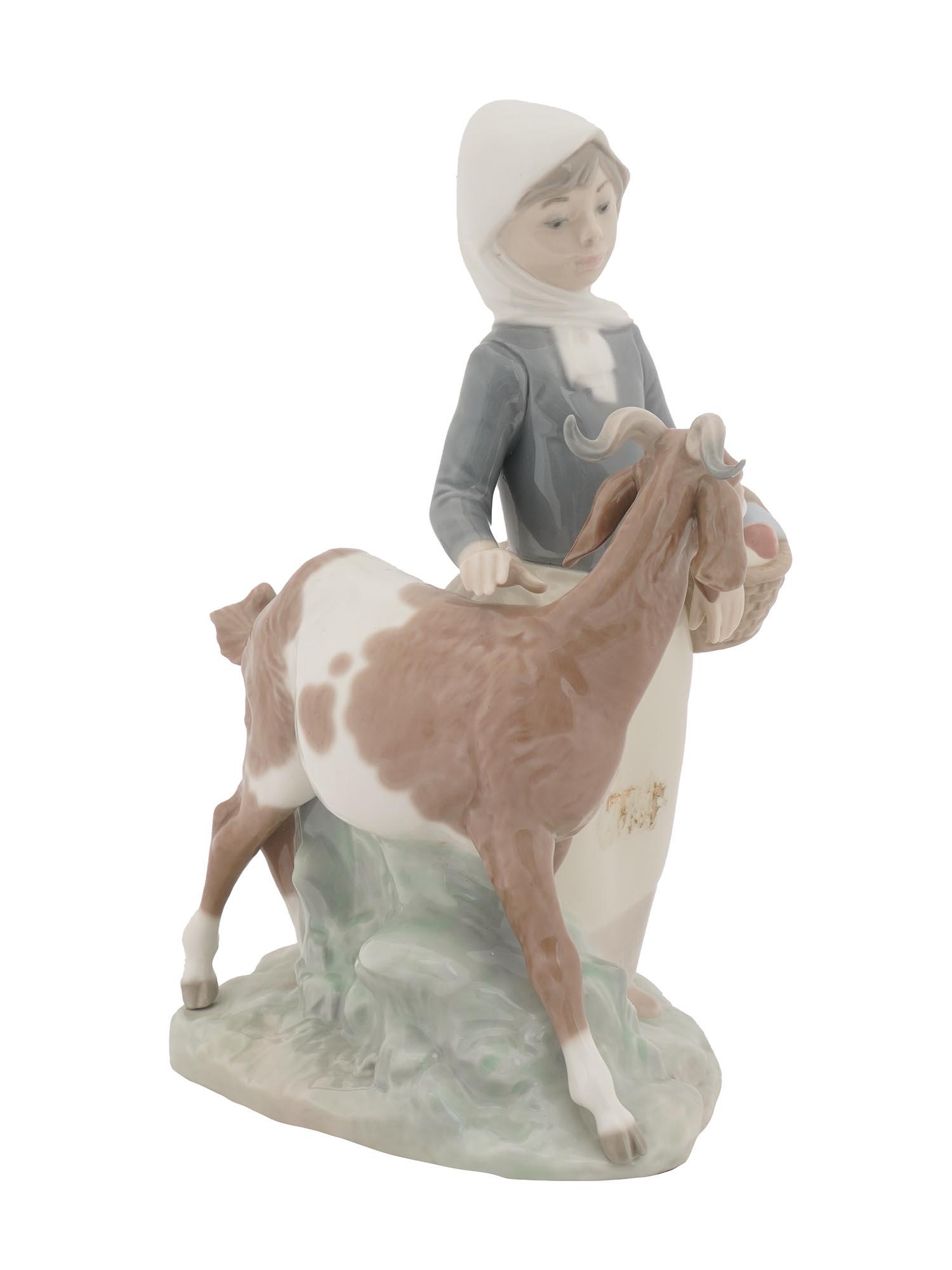 LLADRO SPANISH PORCELAIN FIGURINE GIRL WITH GOAT: A hand-painted porcelain figurine by Lladro, a Spanish porcelain manufacture. The figurine represents a girl with a basket herding a goat. Titled Little Girl With Goat, model 4812, in production until