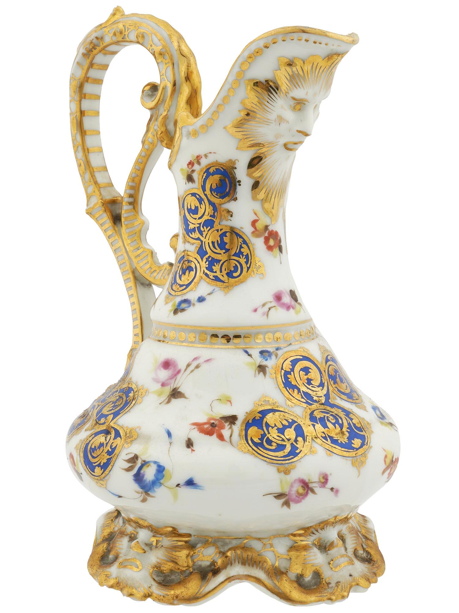 GILDED PORCELAIN MILK JUG MADE FOR TURKISH MARKET: An antique glazed polychrome white porcelain milk jug. The ware was made for Turkish markets. The jug is adorned with a floral pattern, traditional gilt and cobalt blue foliage motif, and gilding. The