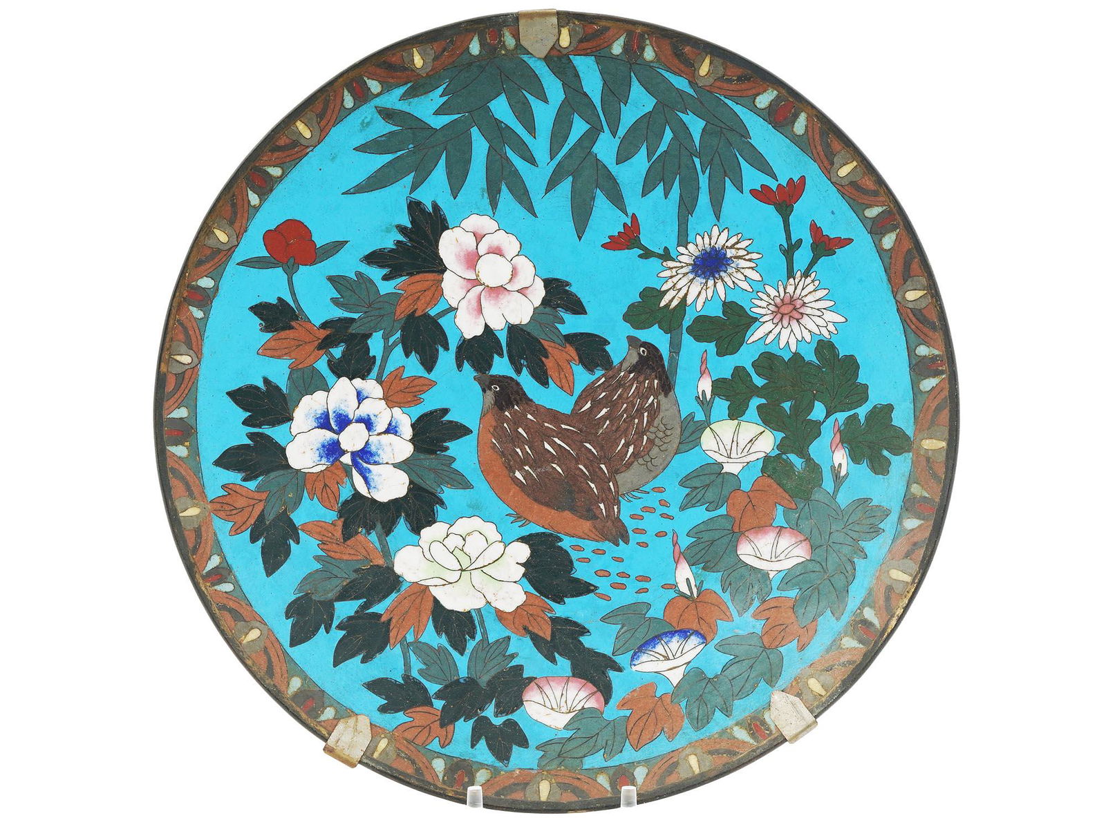 ANTIQUE MEIJI ERA JAPANESE CLOISONNE ENAMEL PLATE: An antique Japanese Meiji period, 1868 to 1912, cloisonne enamel metal charger plate depicting a highly detailed composition with two birds sitting among naturalistic multicolored flowers and foliage
