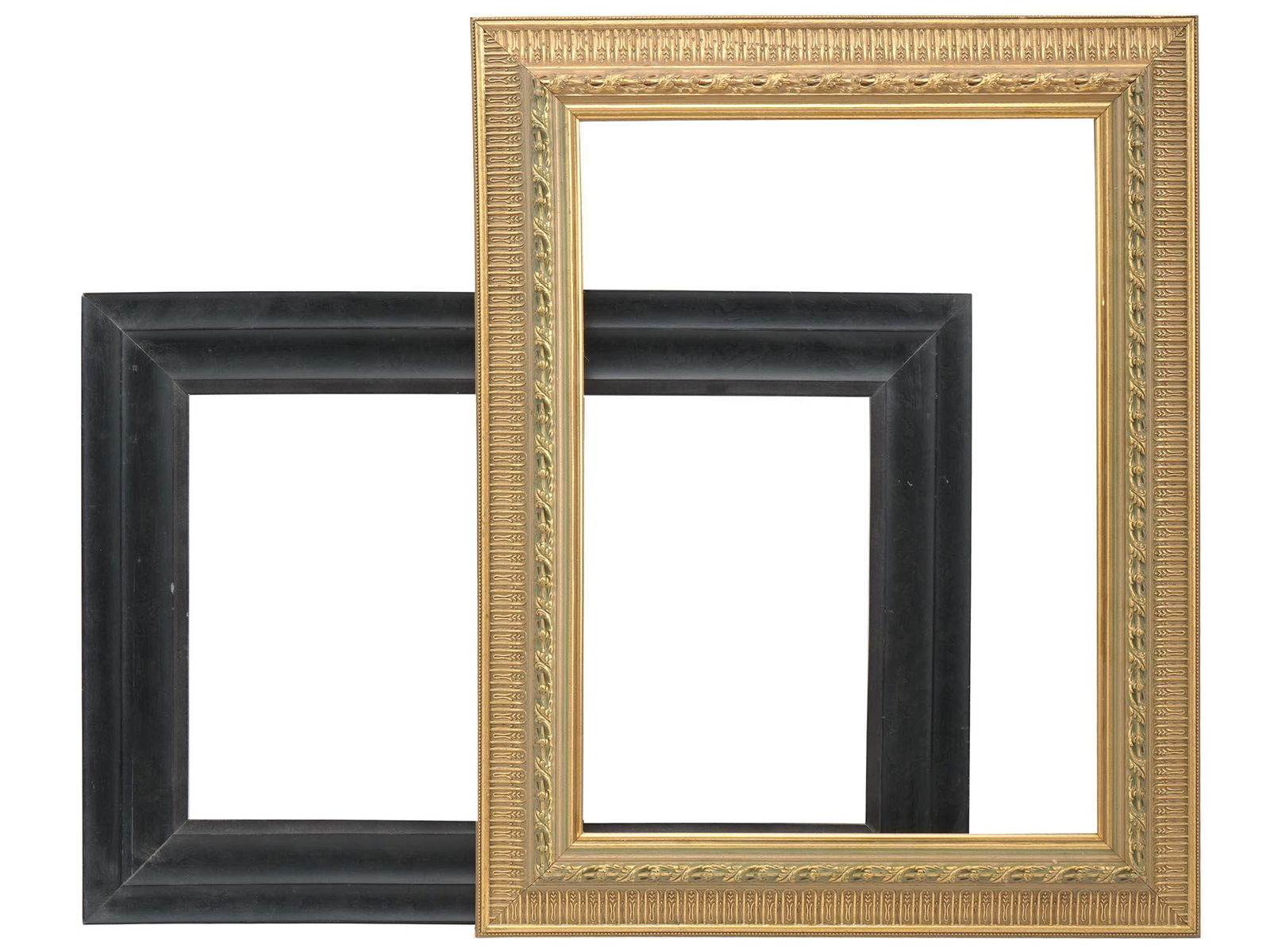 VINTAGE ORNATE WOOD AND PLEIN AIR PICTURE FRAMES: A lot of two vintage picture frames. First. An ornate gilt carved wooden picture frame with floral decor and raised inner edge. There are suspension rings on the backside. Second. A black wooden pictu