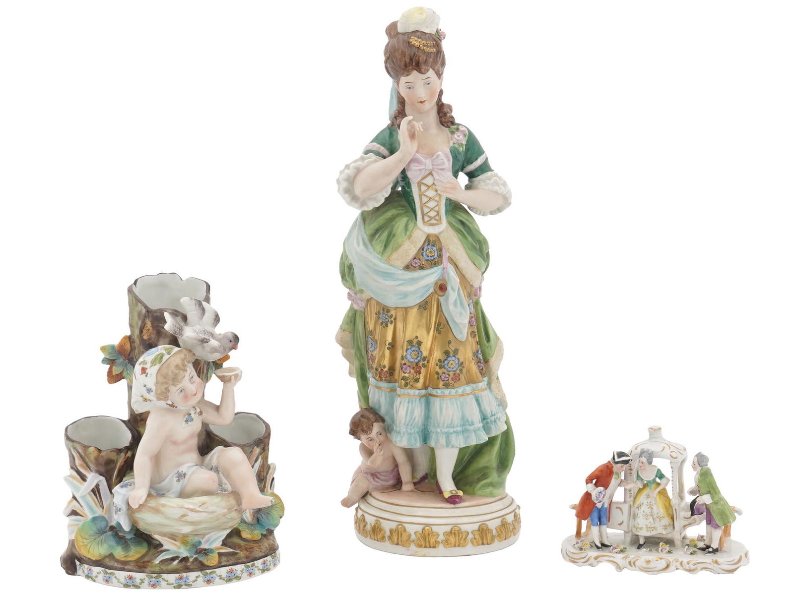 GERMAN PORCELAIN FIGURINES BY SITZENDORF, GOEBEL: A lot of early to mid-20th century German hand-painted porcelain figurines. A total of three items. First. A Rococo female figure in green dress with a putto at her feet. Crossed S mark for Sitzendorf