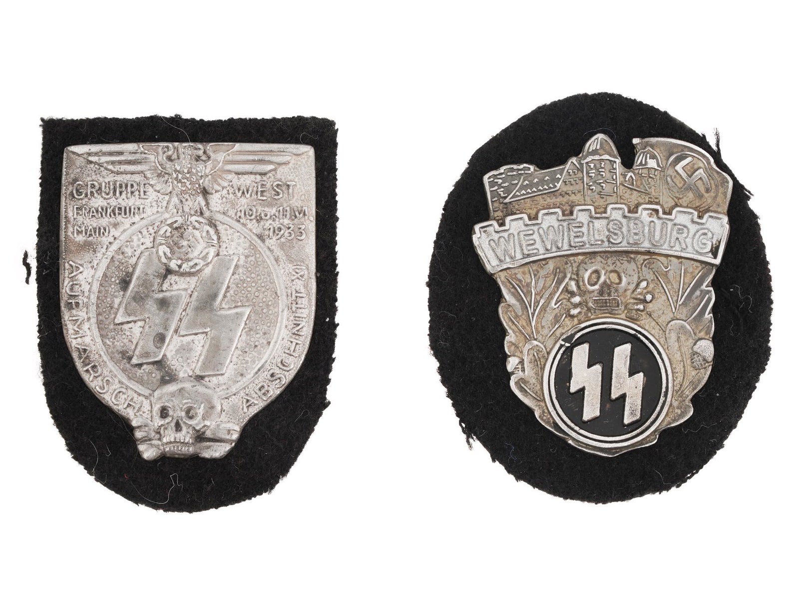 WWII NAZI GERMAN MILITARY METAL PIN SHIELDS: Two WWII Nazi German military metal pin shields including a Waffen SS Academy Wewelsburg black enameled shield, adorned with an image of a castle at the top with a skull in the center and with pair of
