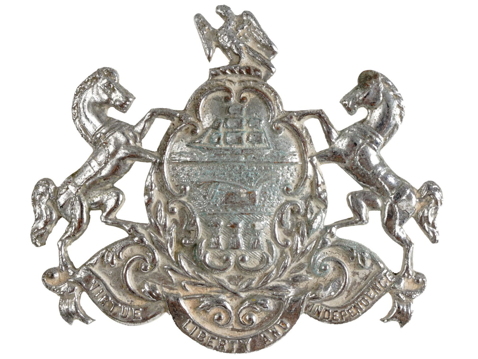 VINTAGE PENNSYLVANIA STATE COAT OF ARMS BROOCH: A vintage embossed silver-tone metal badge representing the coat of arms of Pennsylvania, USA. It features a shield crested by a bald eagle, flanked by horses, and adorned with symbols of Pennsylvania