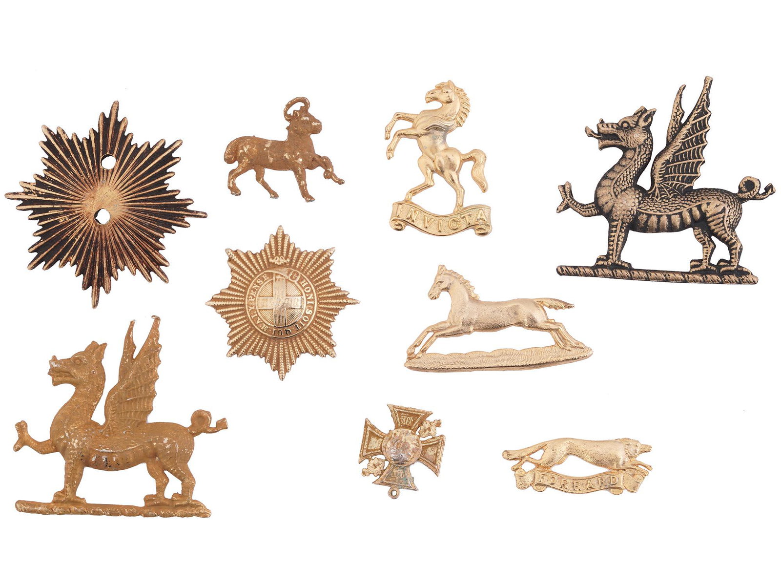 WWII ERA BRITISH MILITARY PINS AND CAP BADGES: A lot of British military pins and cap badges. Dating back to the first half of the 20th-century. A total of 9 items including Monmouthshire Regiment griffins, White Horse of Kent, East Riding of York