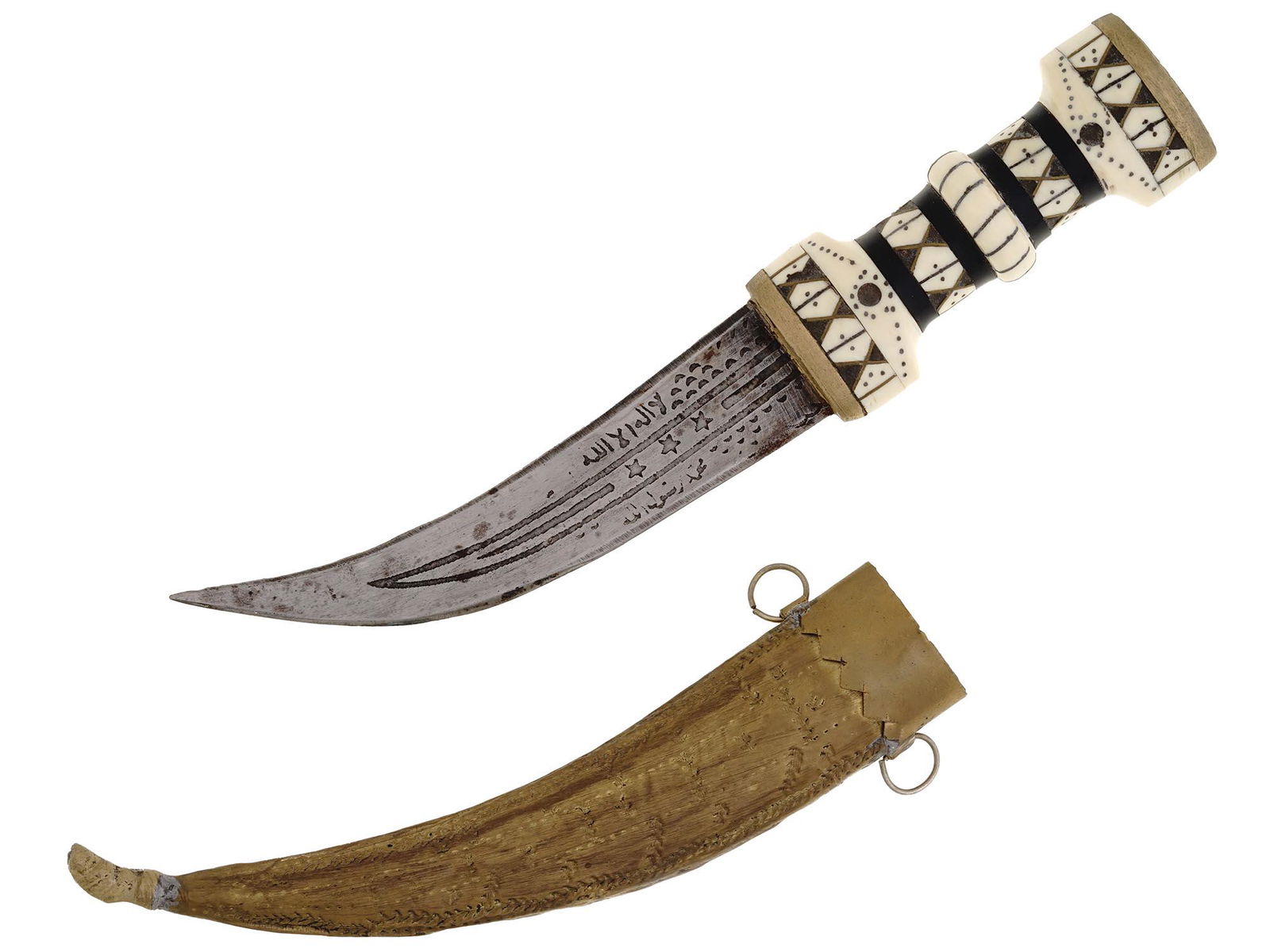 ANTIQUE PERSIAN JAMBIYA DAGGER WITH INLAID HILT: An antique Persian jambiya dagger featuring a curved ridged pointed steel blade with engraved Arab patterns and letterings and a bone inlaid hilt. With the wooden scabbard with leather fittings and tw