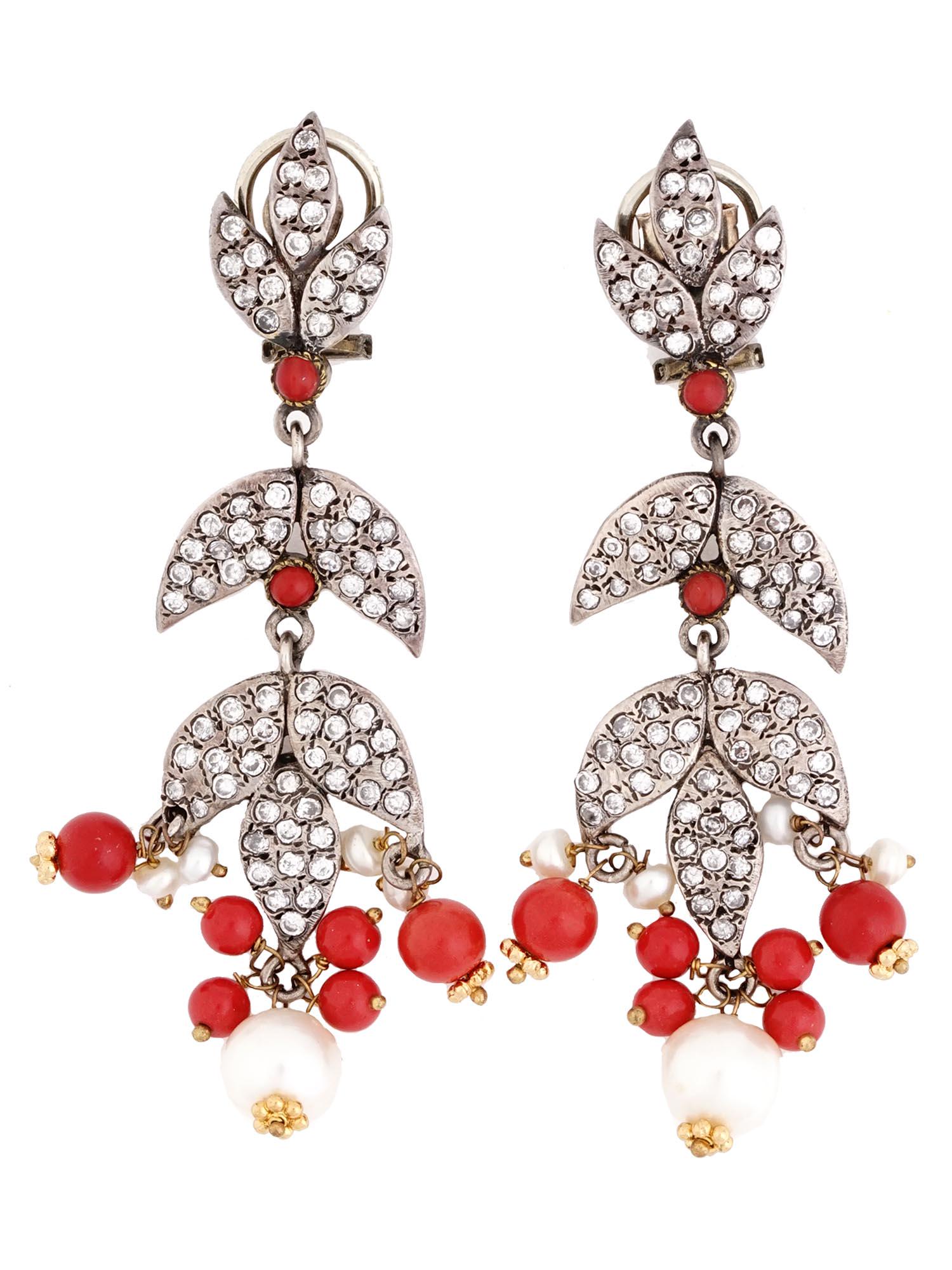 VINTAGE STERLING SILVER CORAL AND PEARL EARRINGS: A pair of vintage sterling silver French clip earrings. A chandelier type of earrings with petal design. The petals are set with rhinestones. Dangling red coral beads and cultured pearls garnish the b