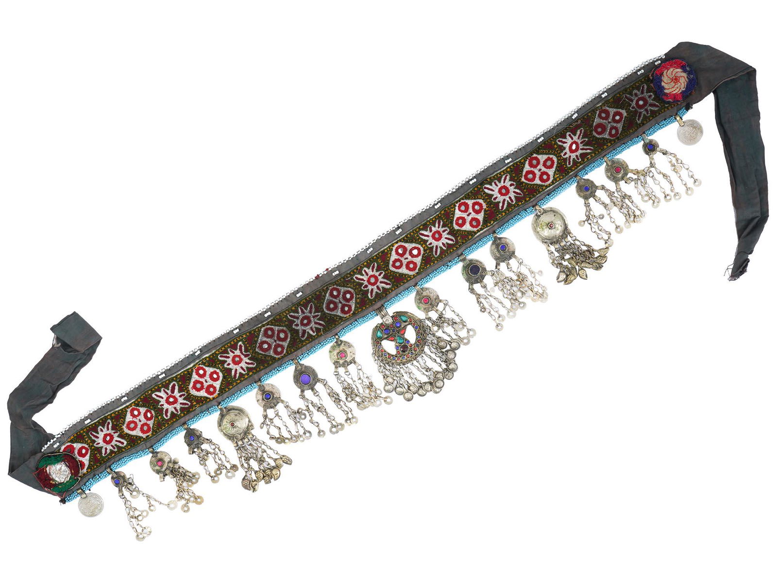 PAKISTANI KUCHI TRIBAL ORNATE BELLY DANCE BELT: A 20th century Pakistani Kuchi Tribal belly dance belt. The belt is made of embroidered velvet fabric, adorned with embroidered and beaded floral and geometrical patterns, hanging adornments, coins wi