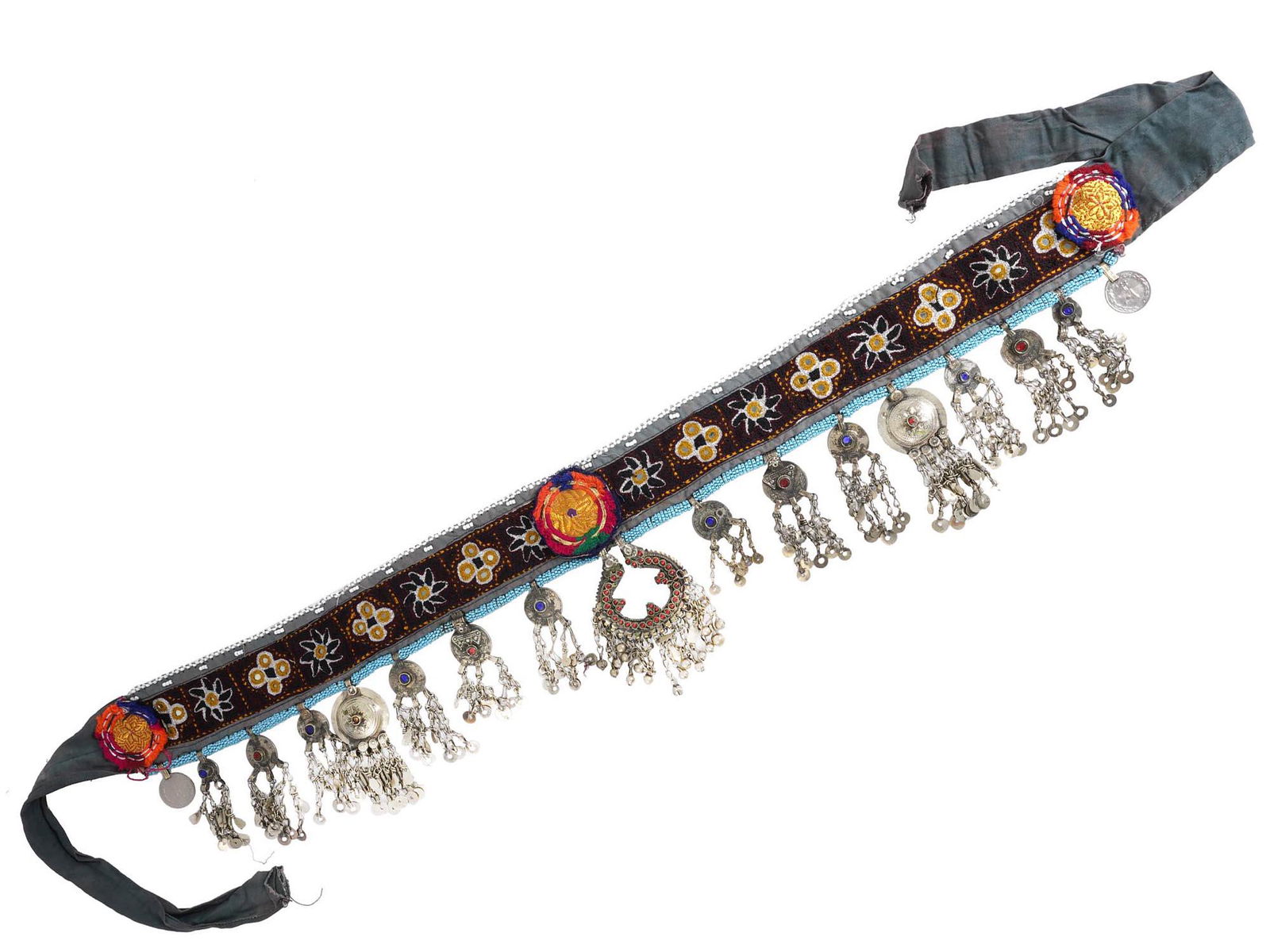 PAKISTANI KUCHI TRIBAL ORNATE BELLY DANCE BELT: A 20th century Pakistani Kuchi Tribal belly dance belt. The belt is made of embroidered velvet fabric, adorned with embroidered and beaded floral and geometrical patterns, hanging adornments, coins, e