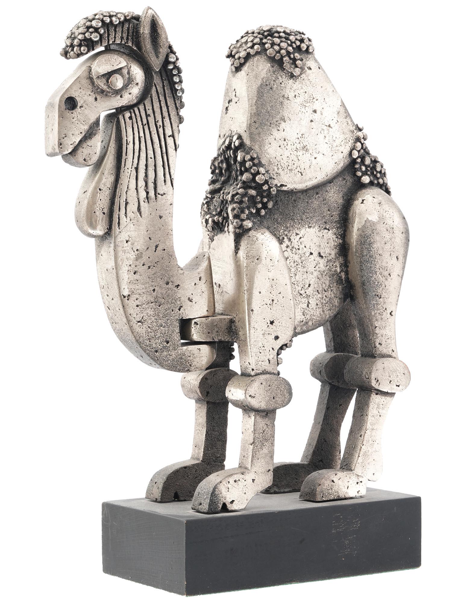 ISRAELI ARTICULATED CAMEL FIGURE BY FRANK MEISLER: Frank Meisler, Israeli, 1929 to 2018, Judaica kinetic articulated silvered aluminum sculpture with moving head, mouth, and neck. The sculpture depicts a standing camel. Mounted on a wooden base. Marke
