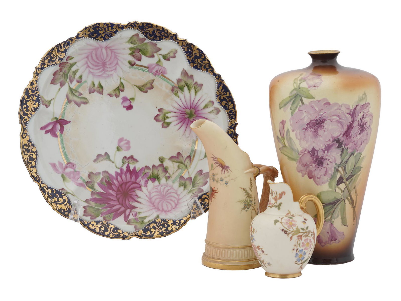 TWO ANTIQUE PORCELAIN PITCHERS BY ROYAL WORCESTER: A lot of four antique porcelain items including two pieces by Royal Worcester, the oldest English manufacture still operating today. First. A blush ivory ewer by Royal Worcester. The jug has golden de