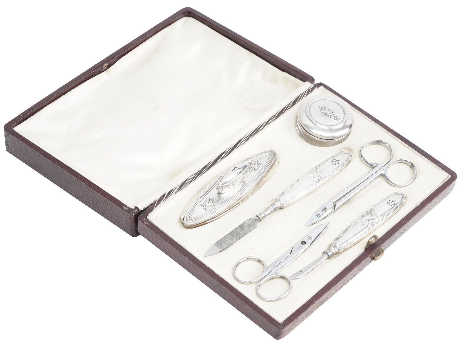 WWII EVA BRAUN MONOGRAMMED MANICURE SET, 6 PCS: A World War II German stainless steel manicure set in original box. The set includes two pairs of manicure scissors, a trimmer, a polissoir, a nail file, and a glass cream box. Each item except for th