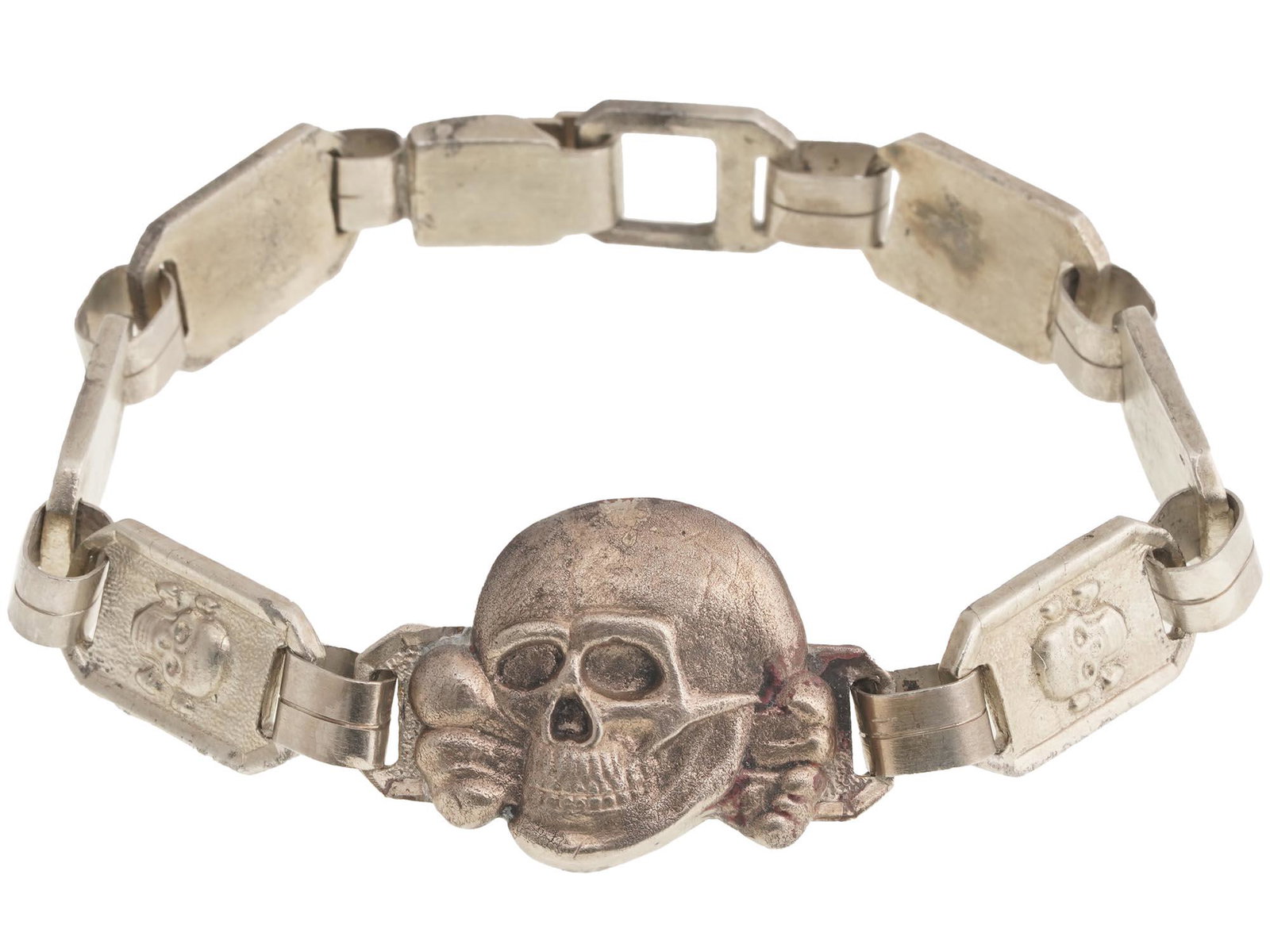 WWII GERMAN WAFFEN SS TOTENKOPF LINK BRACELET: A World War II German nickel-plated steel link bracelet. The links are decorated with relief skulls and SS symbols. The central figurative link represents the Totenkopf, a symbol of often used by Nazi