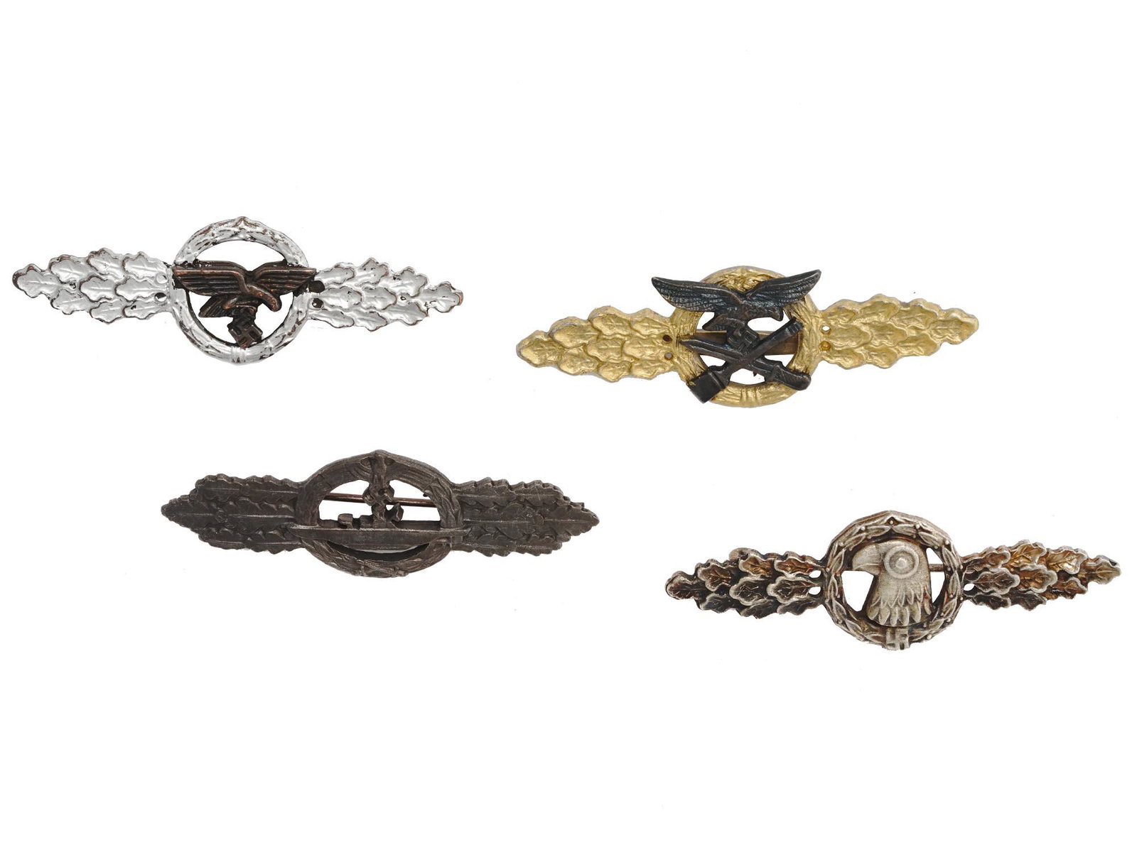 COLLECTION OF WWII NAZI GERMAN THIRD REICH CLASPS: A collection of four WWII Nazi German Third Reich clasps. The collection includes a U boat Combat clasp designed by Wilhelm Ernst Peekhaus, a Glider Squadron clasp, a Close Combat clasp and a Reconnai