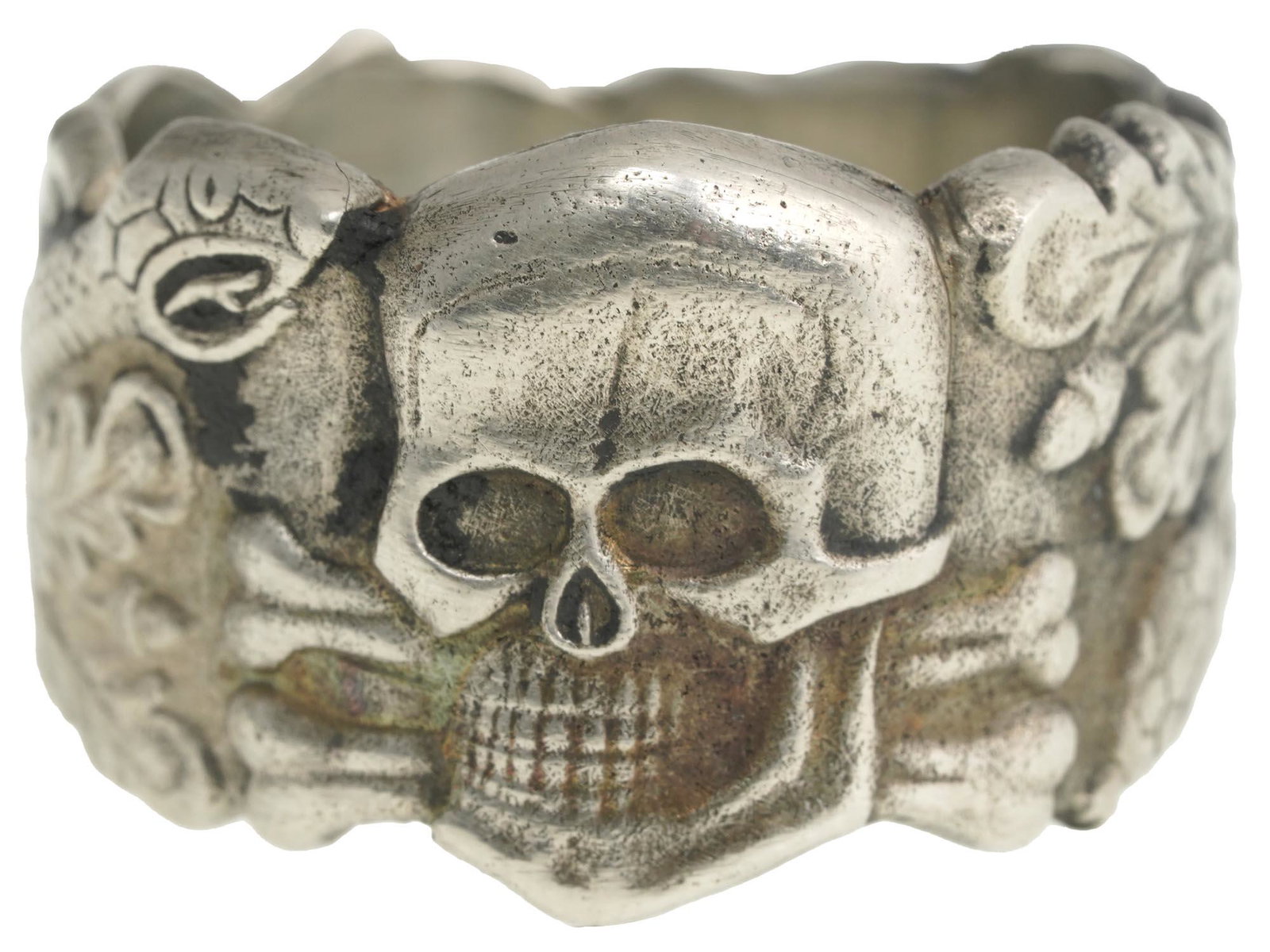 WWII GERMAN ANTI PARTISAN WARFARE TOTENKOPF RING: A WWII Nazi German Third Reich Anti Partisan Warfare Totenkopf ring. The exterior of the ring features an engraved Totenkopf skull in the center and snake and oak leave swastika insignia patterns on t