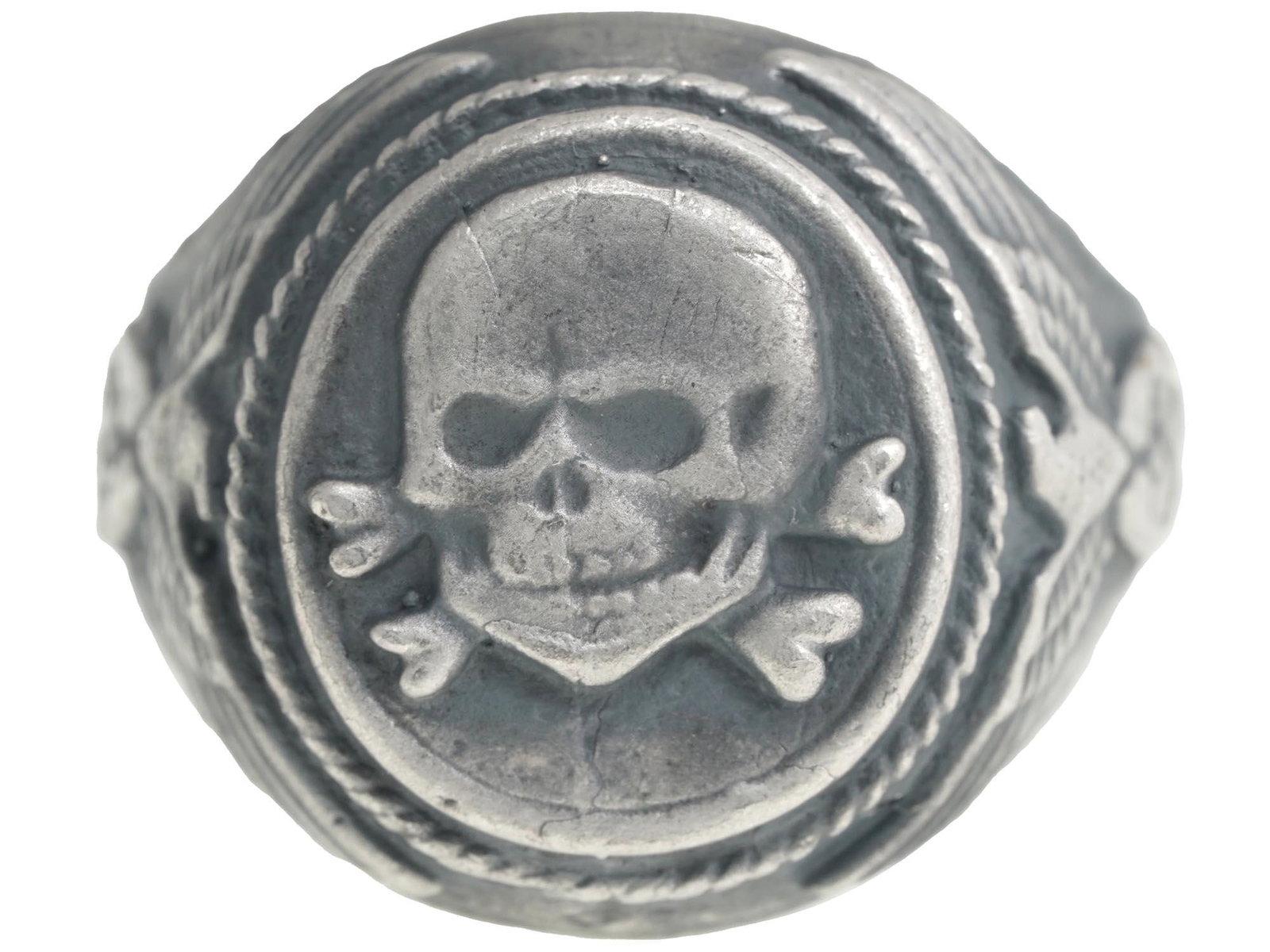WWII GERMAN THIRD REICH WAFFEN SS TOTENKOPF RING: A WWII Nazi German Third Reich Waffen SS Totenkopf silver ring. The exterior of the ring is engraved with eagle swastika insignia patterns on the sides and a skull Totenkopf swastika insignia in the c