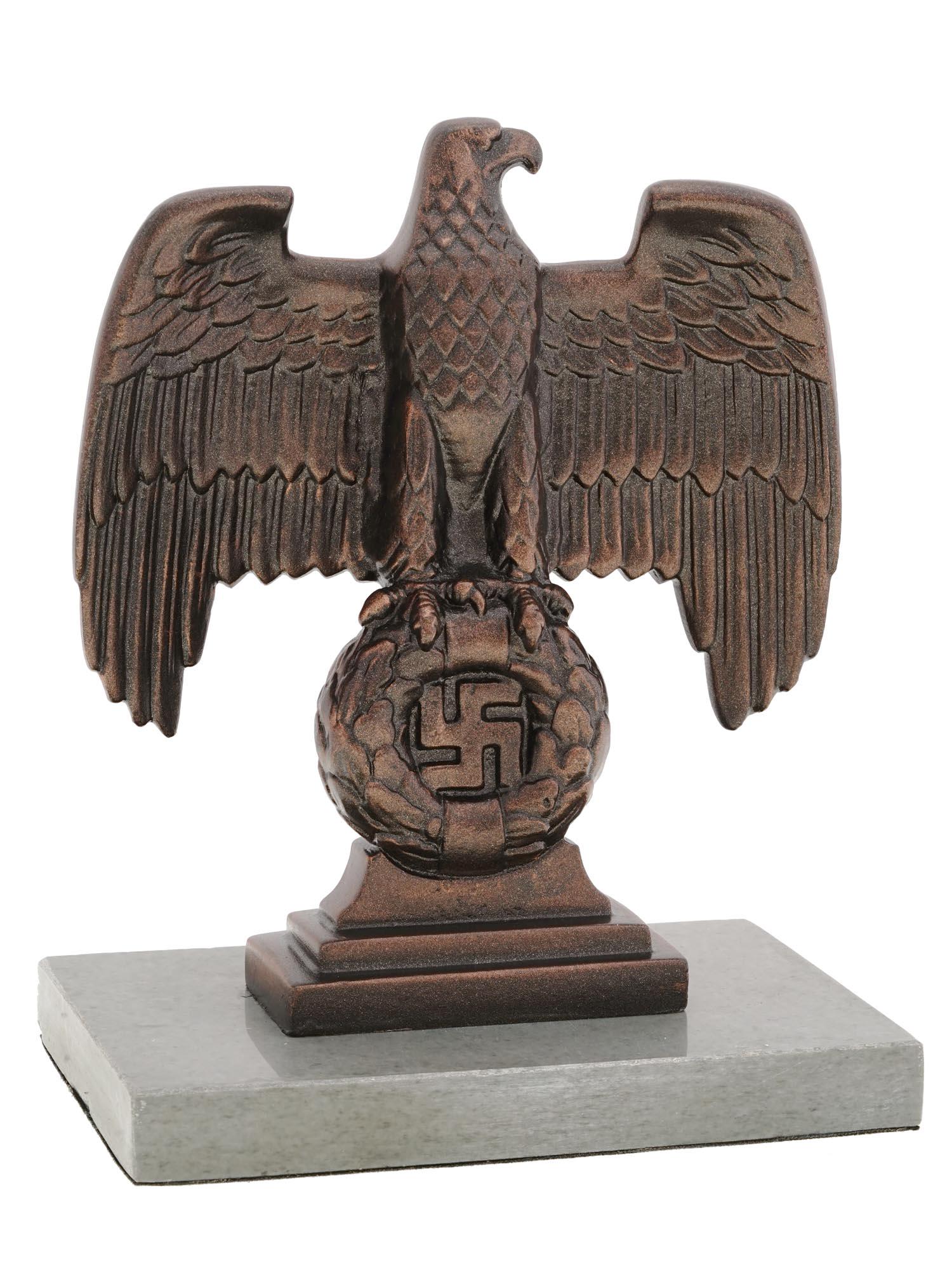 NAZI GERMAN 3RD REICH NUREMBERG DESK EAGLE FIGURE: A WWII Nazi German Third Reich Nuremberg desk eagle figurine. Modeled after the bronze Nuremberg eagles positioned to each side of the main podium at the Nuremberg rally grounds. Mounted to a gray mar