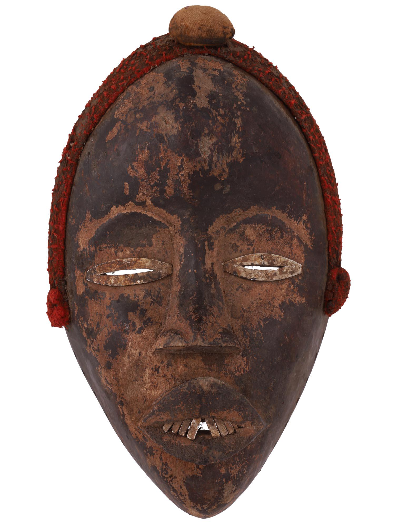 ANTIQUE AFRICAN CARVED WOOD MANDE TRIBAL DAN MASK: An antique traditional African hand carved wood tribal mask of the Dan people, a Mande ethnic group from northwestern Ivory Coast and neighboring Liberia. They are officially known as Yacouba in Ivory
