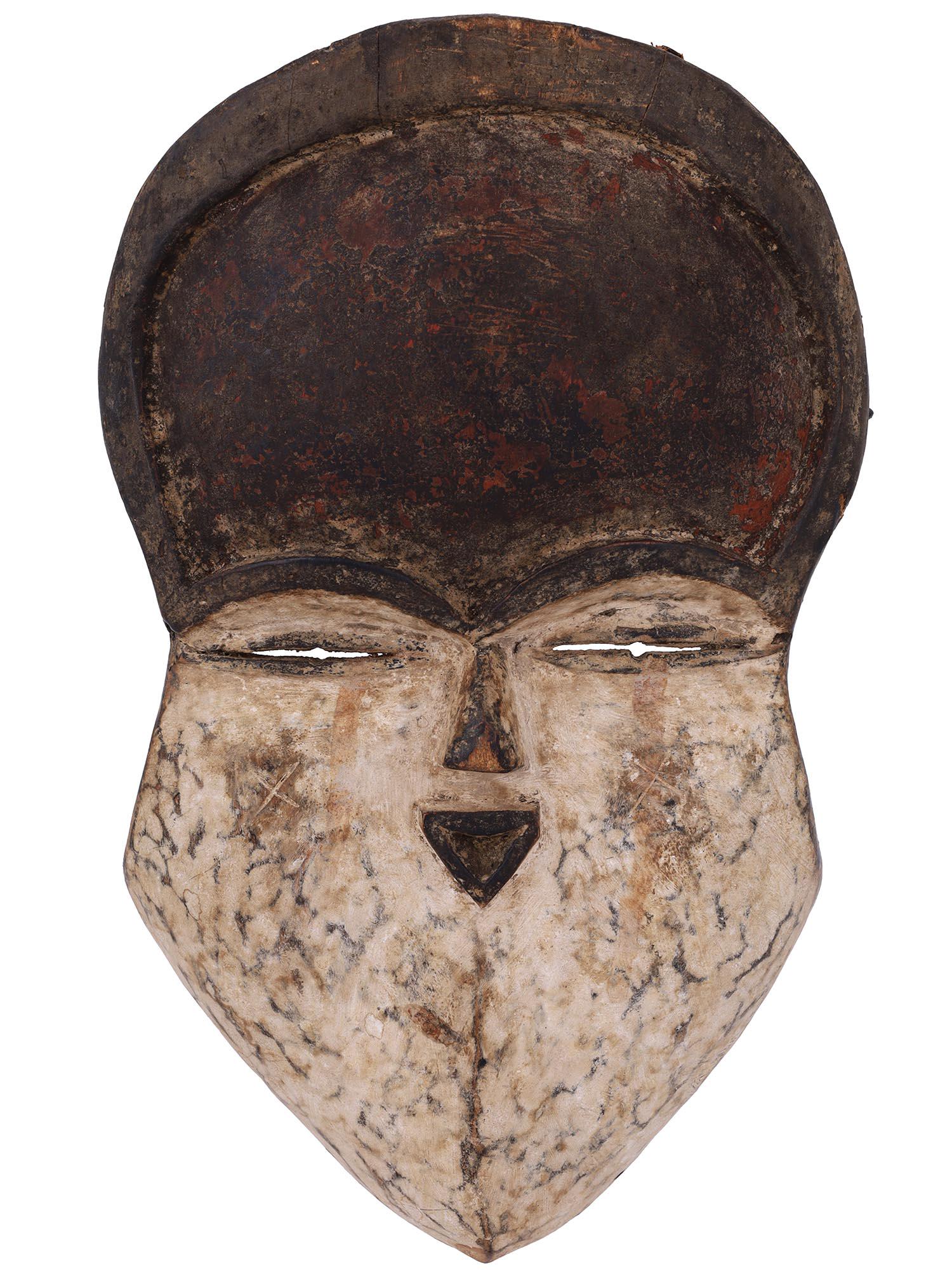 ANTIQUE AFRICAN GABON CARVED WOOD VUVI TRIBE MASK: A rare antique traditional African hand carved wood tribal mask from the Vuvi tribe of Gabon. The face depicts gently arching brows above thin, slit-like eyes, delicately carved nose and sensual lips.