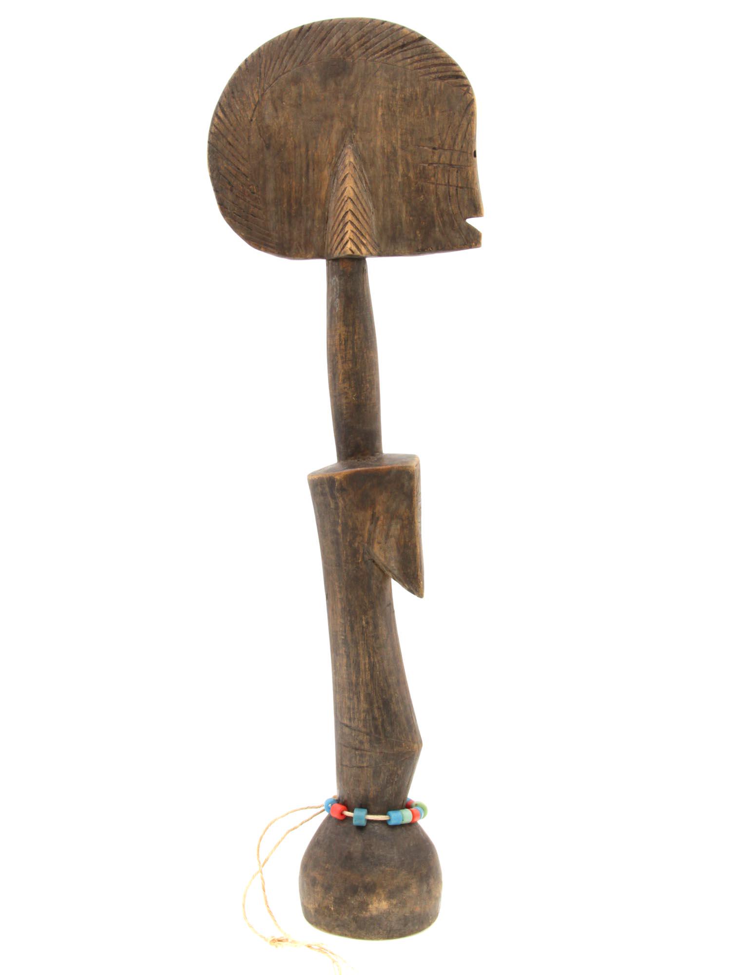 AN ANTIQUE AFRICAN WOODEN FERTILITY FIGURE: An early 20th-century Mossi People wooden fertility figure from Burkina Faso, West Africa. The protrusions on the sides of the flat head mimic the hairstyle of an unmarried woman. A figurine with a lo