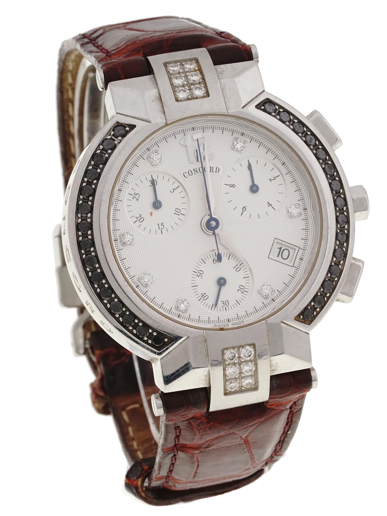 CONCORD LA SCALA WOMENS CHRONOGRAPH WRIST WATCH: A vintage womens chronograph wristwatch by Concord, a Swiss luxury goods company. La Scala model. Round stainless steel bezel embellished with black and white diamonds, white guilloche dial with diamo