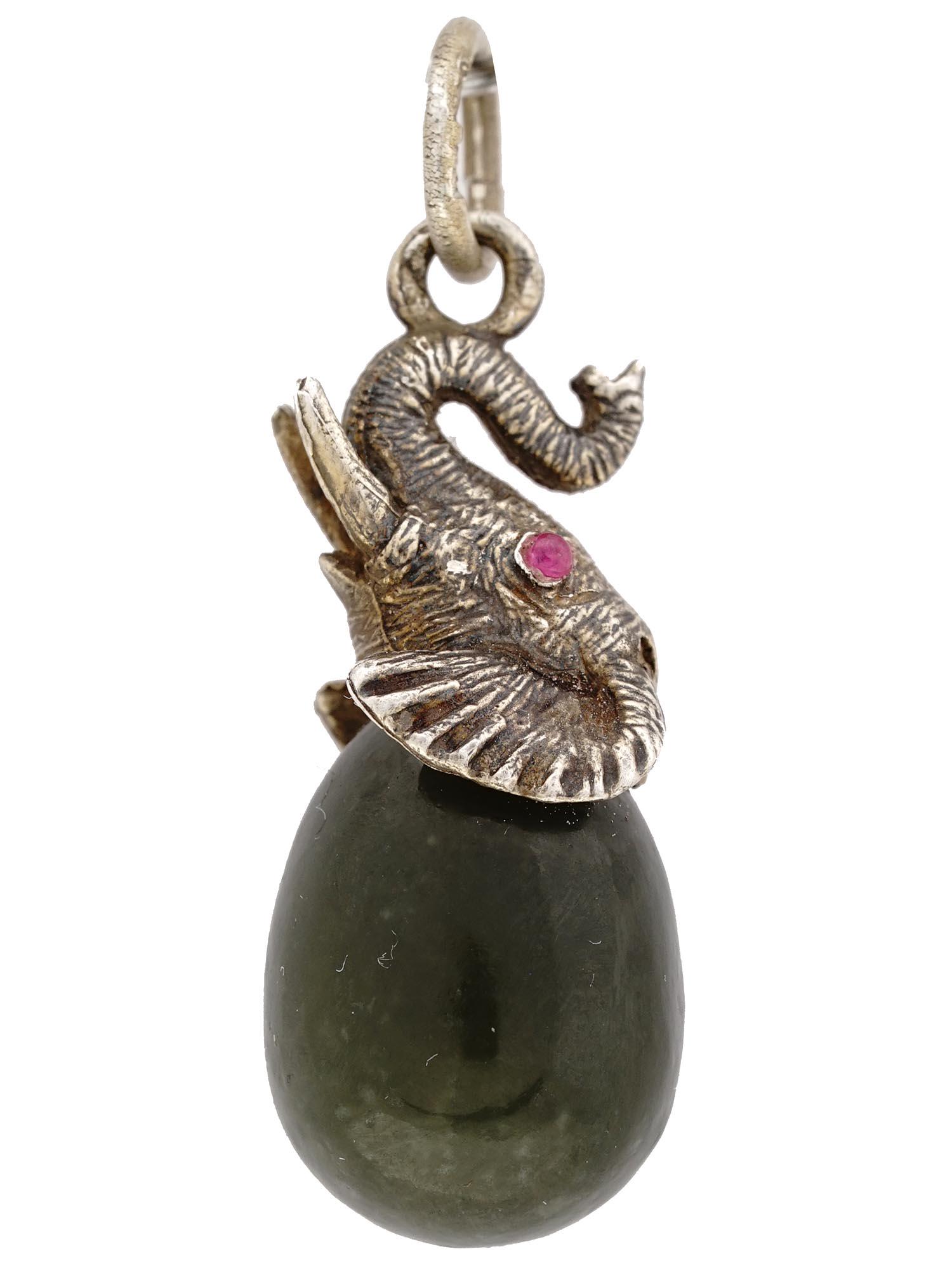 IMPERIAL RUSSIAN SILVER JADE ELEPHANT EGG PENDANT: An Imperial Russian jade egg-shaped pendant with a figurative silver upper part representing an elephant. The eyes of the elephant are set with faceted rubies. Hallmark of 84 silver standard and maker