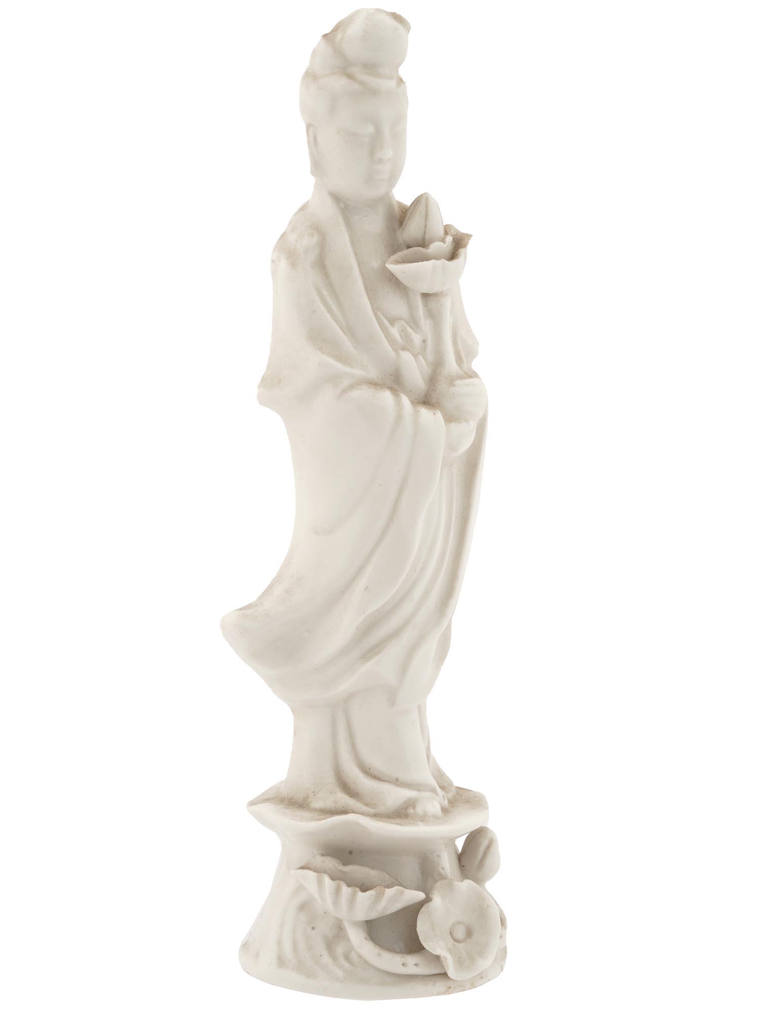 ANTIQUE BLANC DE CHINE PORCELAIN GUANYIN FIGURE: An antique Chinese glazed Dehua porcelain sculpture. Late Qing dynasty, before 1912. The artwork represents Guanyin, a Chinese Bodhisattva associated with compassion, with lotus flowers at her feet. T
