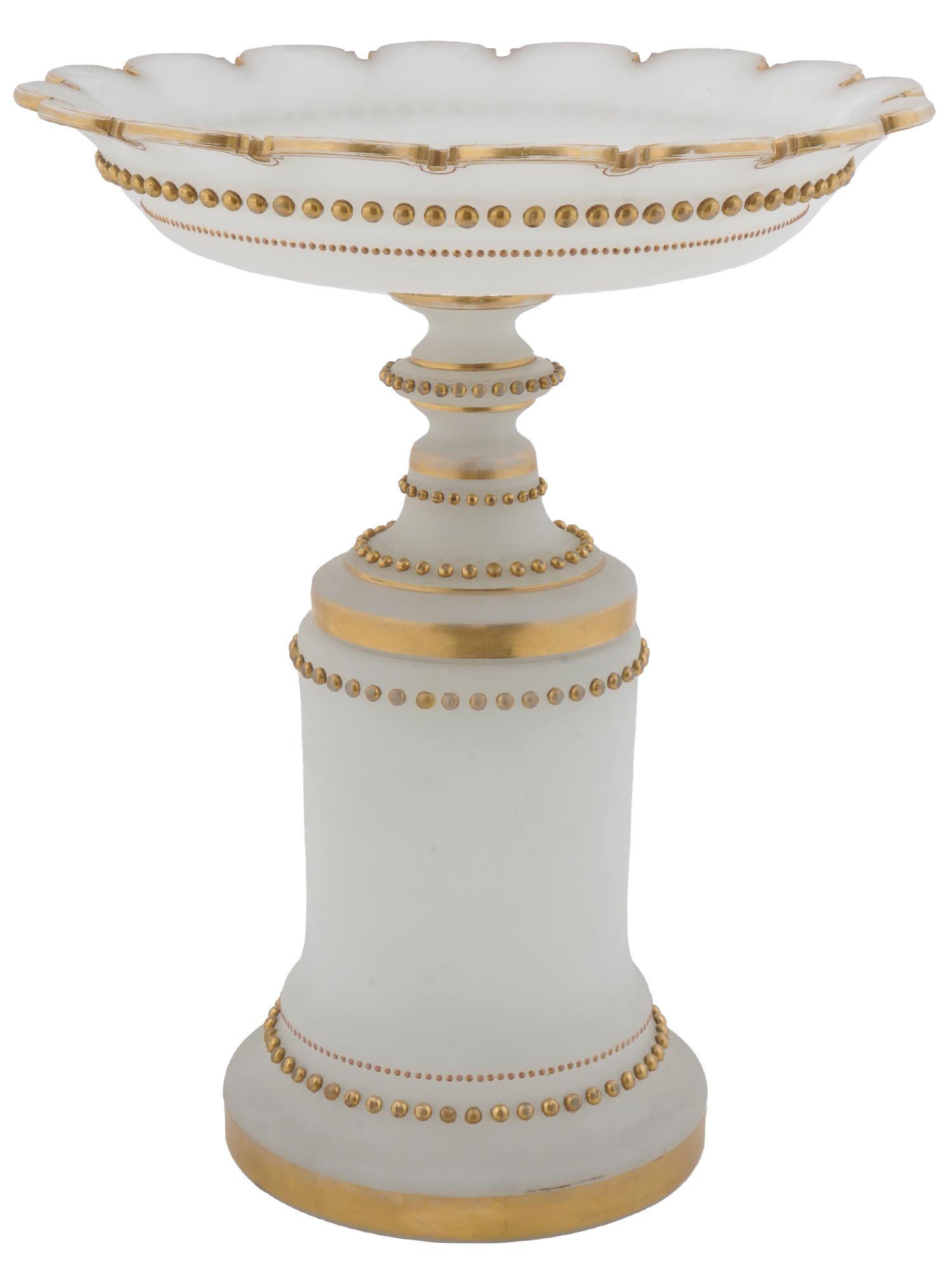 GILT WHITE OPALINE GLASS FRUIT BOWL WITH STAND: A vintage white opaline glass fruit vase with gilt rims and accents. The footed vase rests on a matching stand. Collectible Glassware Tableware Serveware And Decor. Dimensions: H 17 1/2 in. D 14 in. A