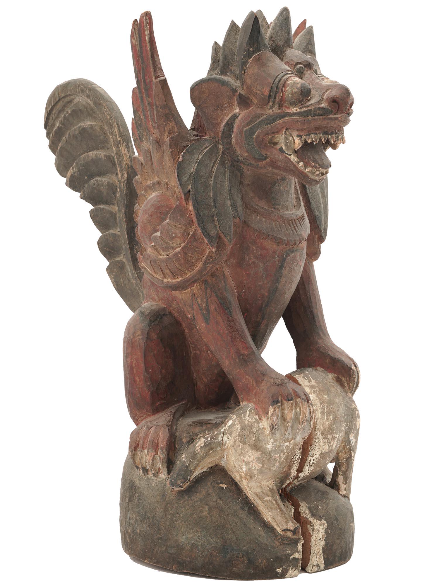 BALINESE SINGA BERSAYAP HAND CARVED WINGED LION: A mid 20th-century Balinese polychrome hand-carved wooden sculpture of a winged lion, also known as Singa Bersayap. Fine detail work. In Balinese mythology, the lion is the king of the forest, a prote