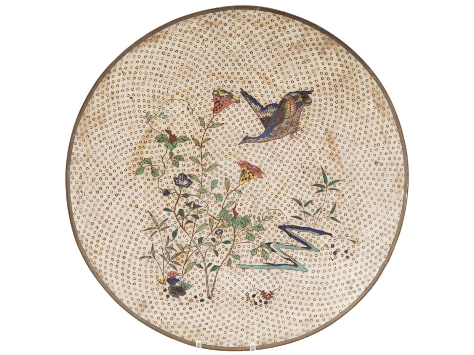 ANTIQUE MEIJI ERA JAPANESE CLOISONNE ENAMEL PLATE: An antique Japanese Meiji era enamel metal plate. Circa: late 19th century to early 20th century. The plate is enameled with a polychrome scene depicting a bird in a garden with blossoming sakura flow