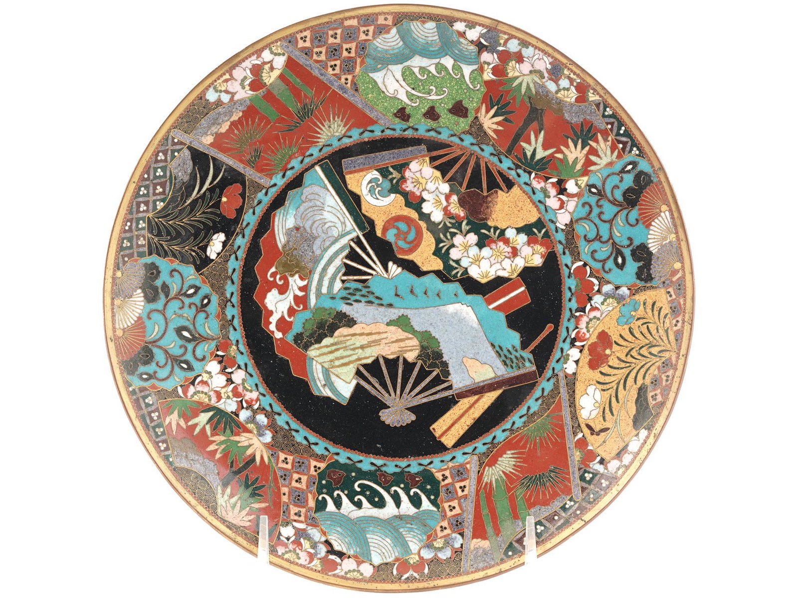 HIGH QUALITY ANTIQUE JAPAN CLOISONNE ENAMEL PLATE: A high quality antique Japanese Meiji Era enamel plate. Circa: early 20th century. The interior of the plate is enameled with a polychrome medallion with images of fans to the center surrounded by med