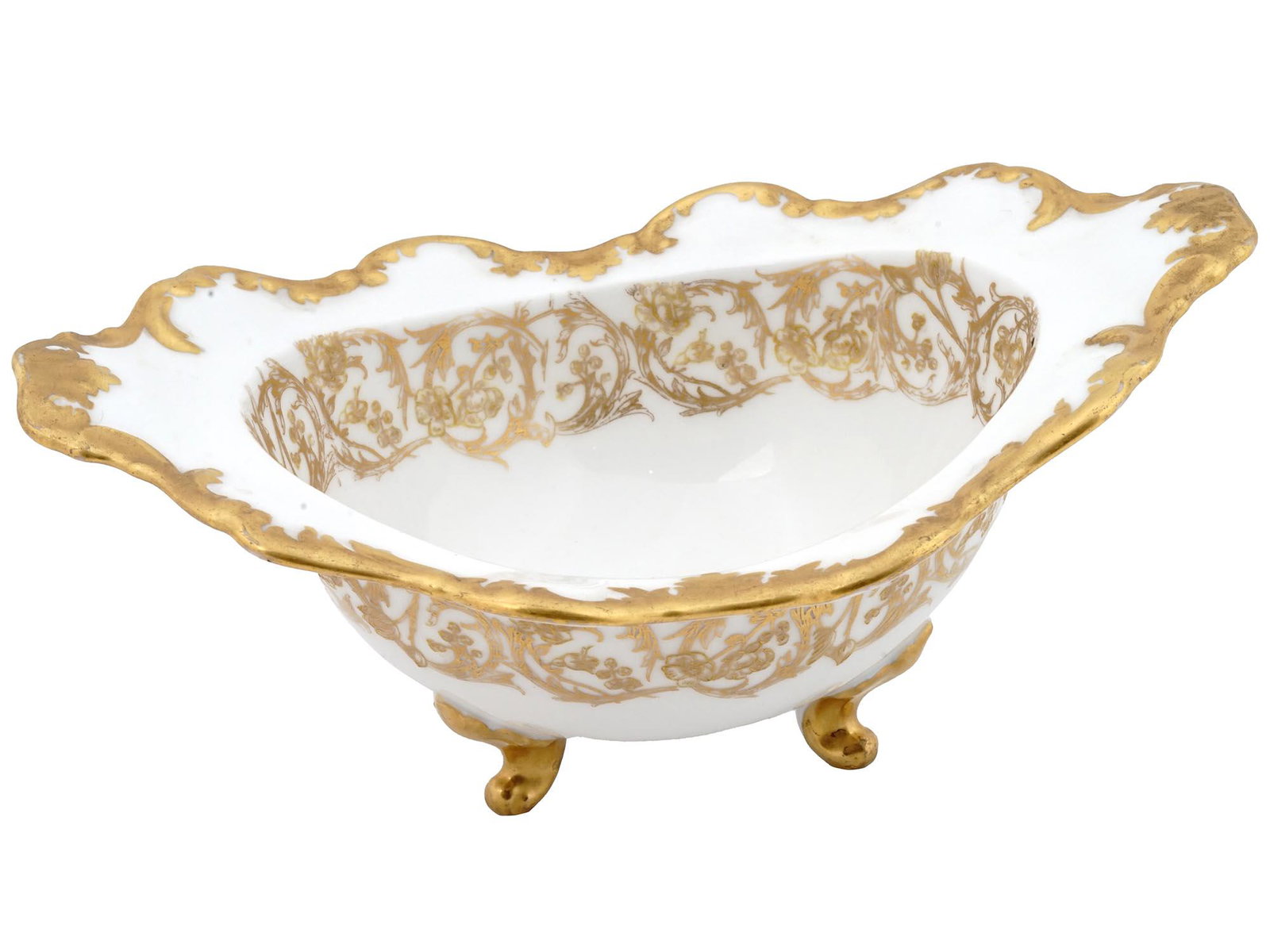 TRESSEMAN AND VOGT LIMOGES GILT PORCELAIN BOWL: An antique French footed porcelain serving bowl by Tressemanes and Vogt, a porcelain manufacturer based in Limoges, active from the 1880s to 1919. The feet and figurative rims are gilt, the body is ri