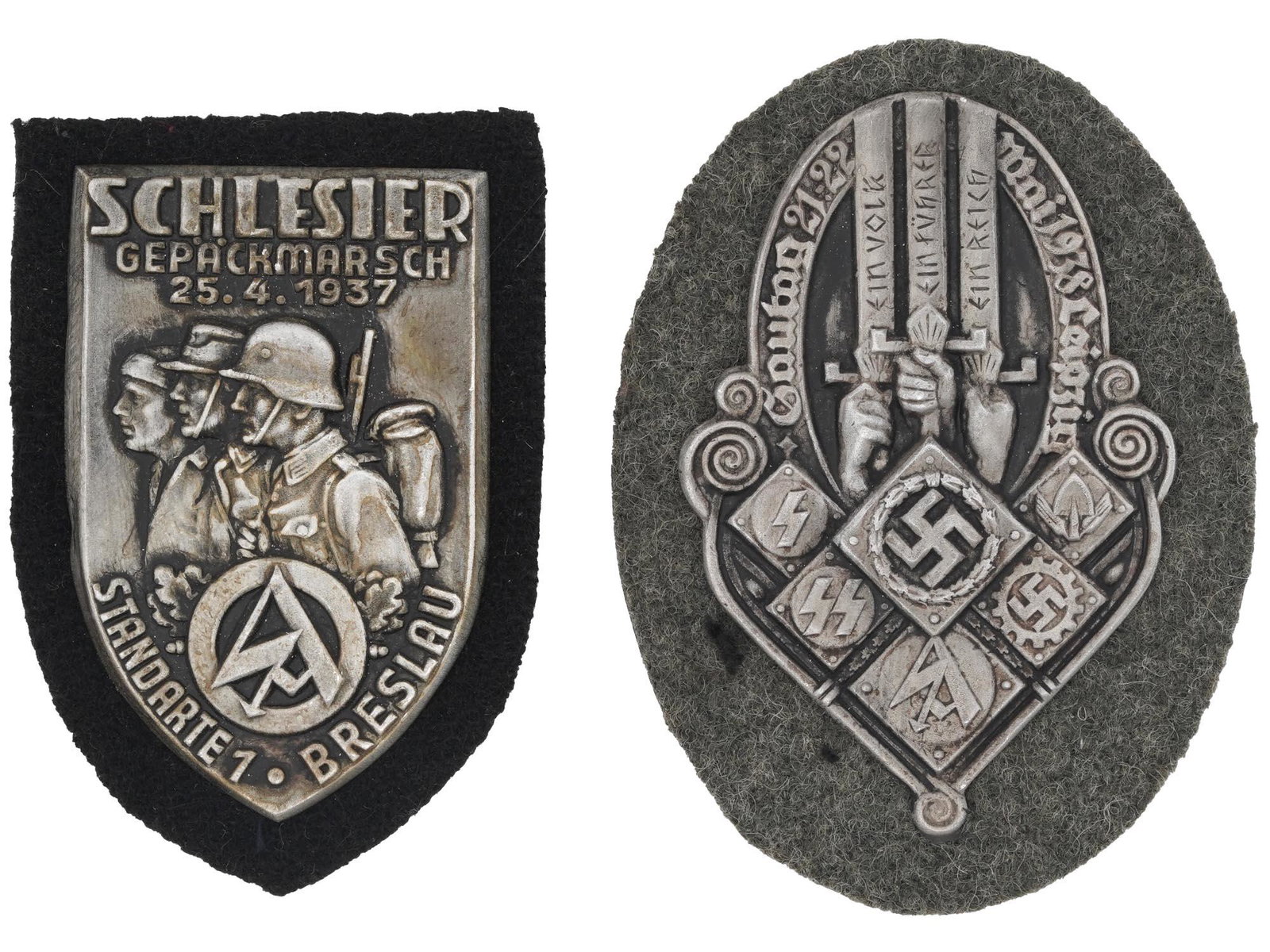 WWII GERMAN NAZI THIRD REICH MILITARY PIN SHIELDS: A pair of WWII German Nazi Third Reich Military metal pin shields. The first: Gautag Leipzig Organizations badge with engraved swastika insignias. The second: Silesian baggage march standard Breslau, 