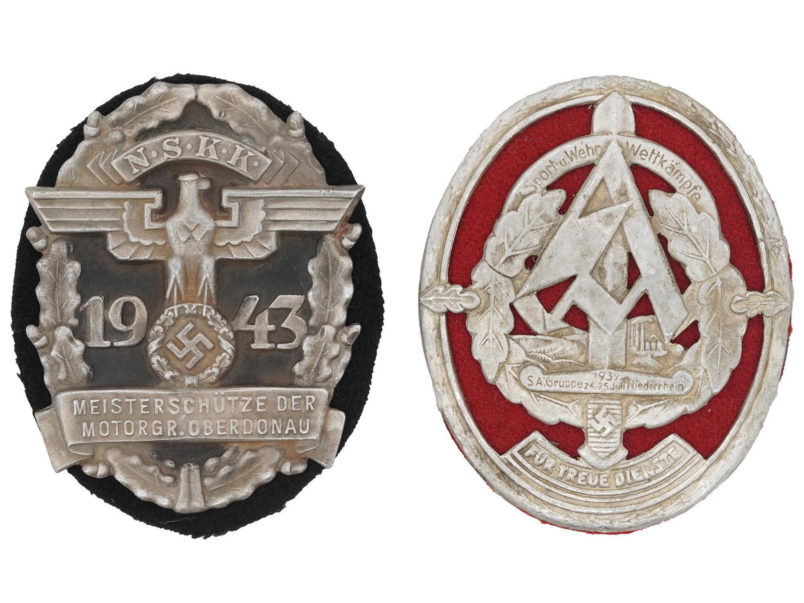WWII NAZI GERMAN THIRD REICH NSKK AND SA SHIELDS: A pair of WWII Nazi German Third Reich metal shields. The first: NSKK Motorgruppe Oberdonau oval form shield, with a black base and a bas relief with a Nazi eagle with a swastika insignia, and an insc