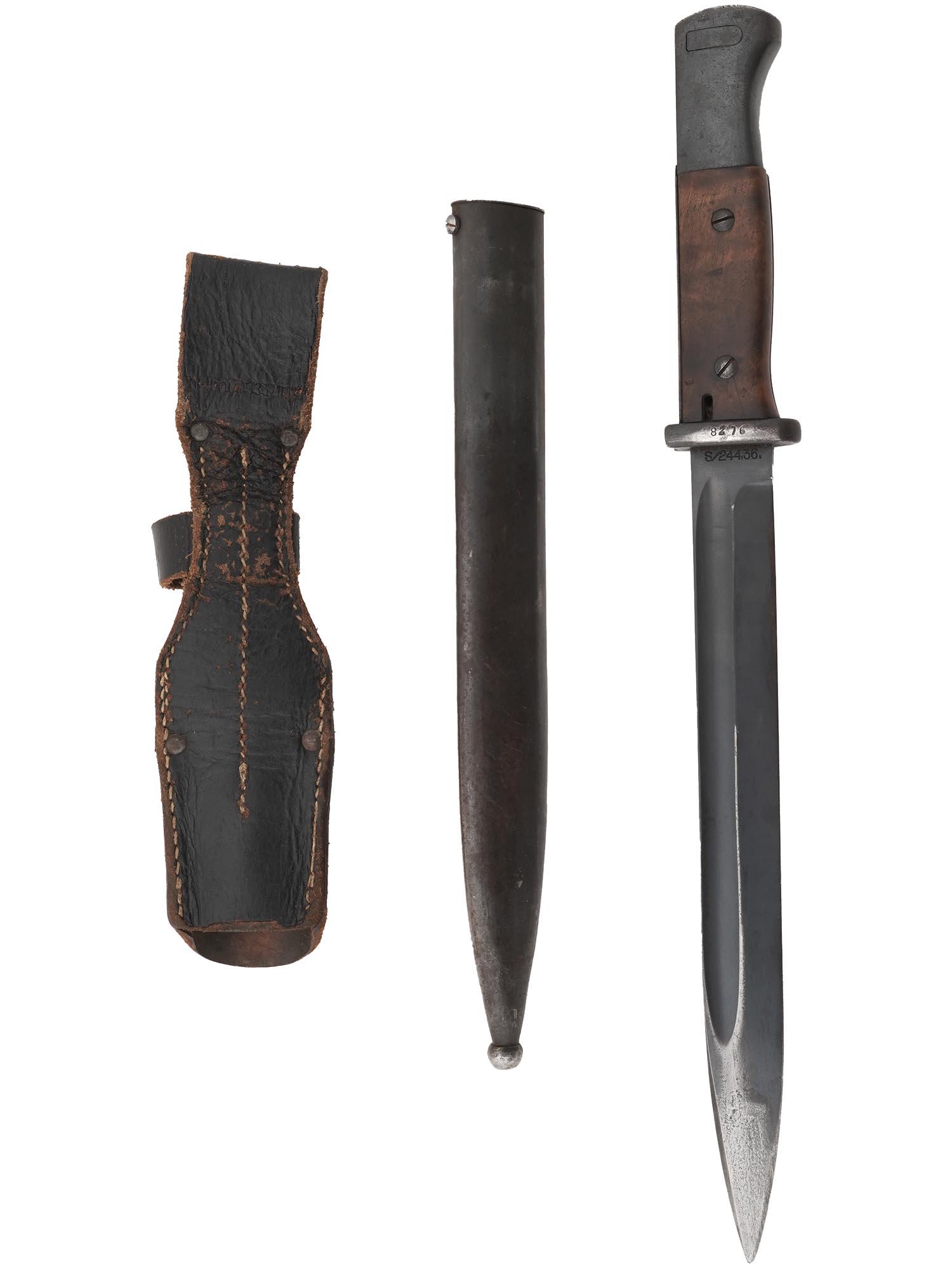 WWII NAZI GERMAN BAYONET IN SHEATH: A World War II German Bayonet. Stainless steel blade, oval crossguard, wooden handle. Leather and steel sheath. Numbers 8276, S24436, and 8276 K are on the blade and crossguard. The combat knives beca