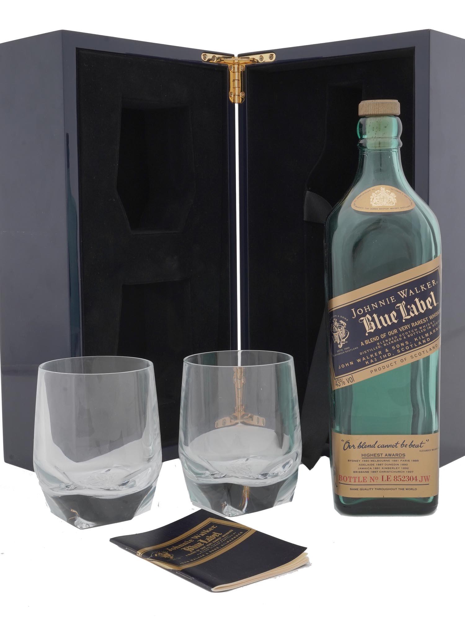 JOHNNIE WALKER BLUE LABEL WHISKY BOTTLE CUPS BOX: A Johnnie Walker Blue Label blended scotch whisky set of an empty bottle, a pair of cups, and a box by John Walkers and Sons. Bottled in Scotland. The glass cups are marked with a stamp on the bottom.