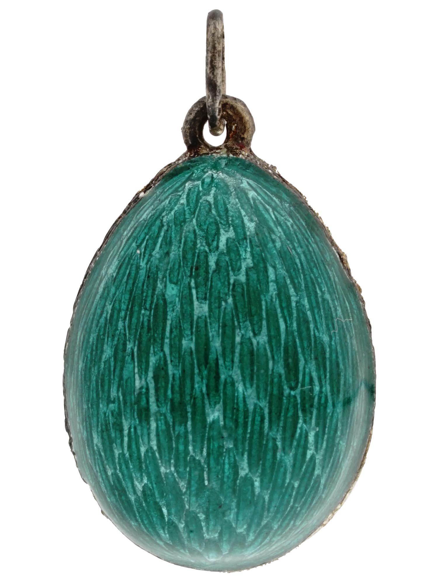 RUSSIAN GILT SILVER AND GREEN ENAMEL EGG PENDANT: A Russian gilt silver egg-shaped pendant with green enameled surface. Traces of a silver standard hallmark are on the suspension ring. Weight: 6.7 grams. Russian Jewelry, Silverware And Collectibles. 