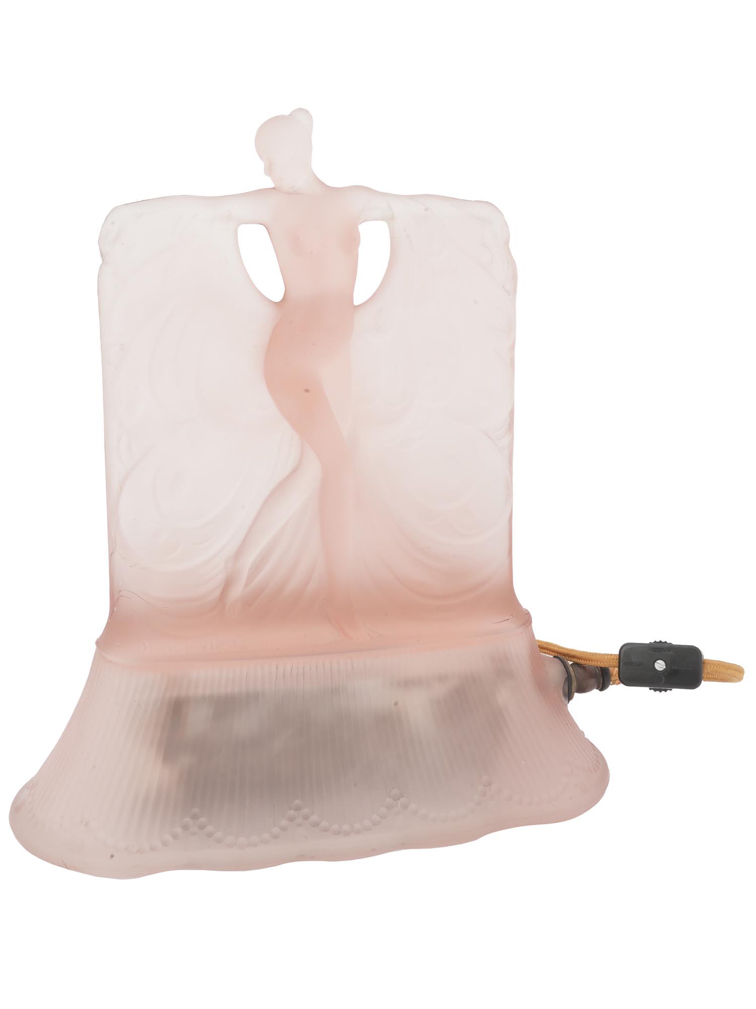VINTAGE ART DECO MCKEE DANSE DE LUMIERE GLASS LAMP: A vintage American Art Deco molded glass lamp manufactured by McKee. Depicts a nude with arms extended holding a flowing cape, on a flared base, in matte finish. Inscribed Danse de Lumiere on the fron
